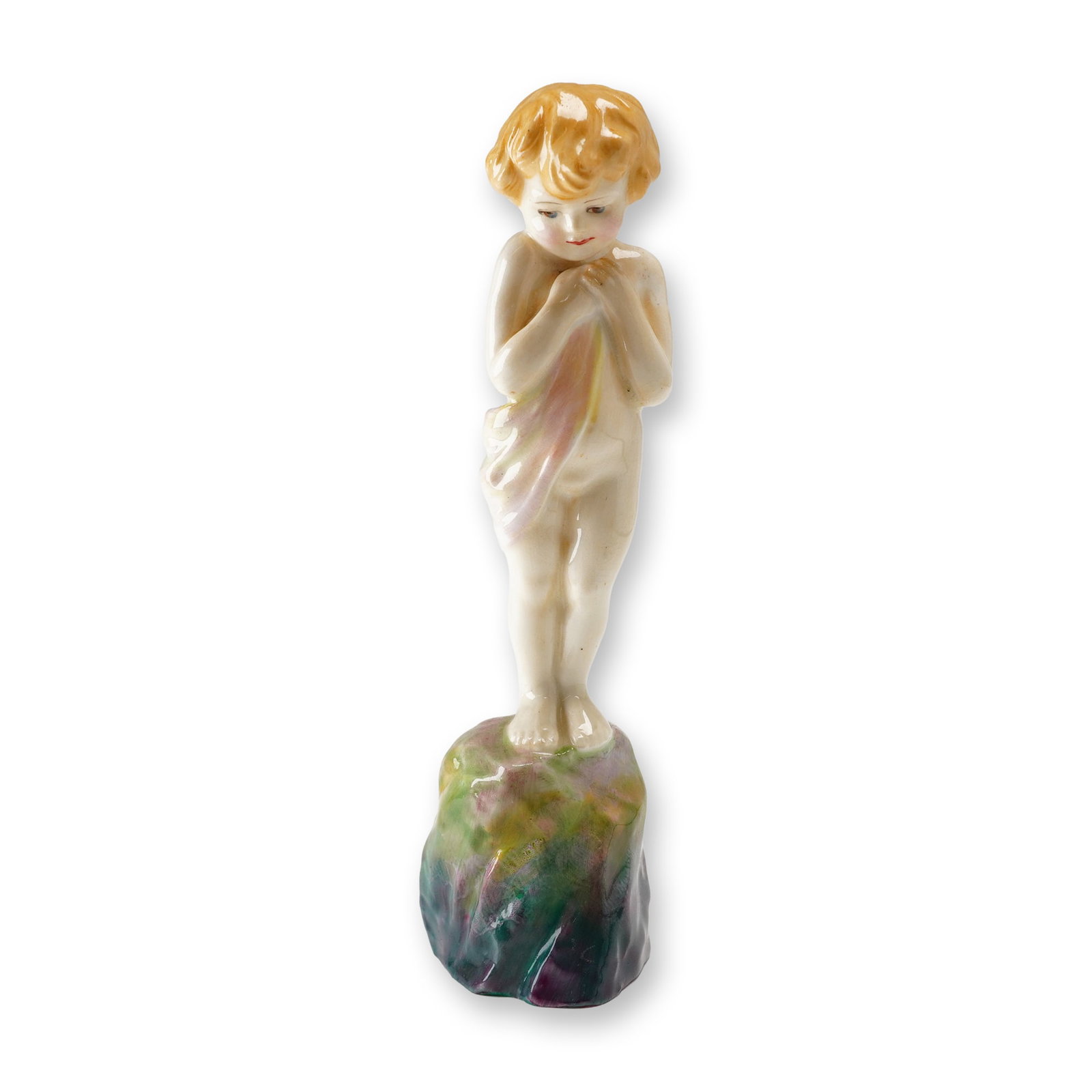Royal Doulton Porcelain Figurine, Happy Joy, Baby Boy HN1541: Designed by Leslie Harradine, features a young boy in a pensive pose standing upon a multicolored rocky base. The figure is partially draped in a translucent-appearing cloth with delicate washes of pi
