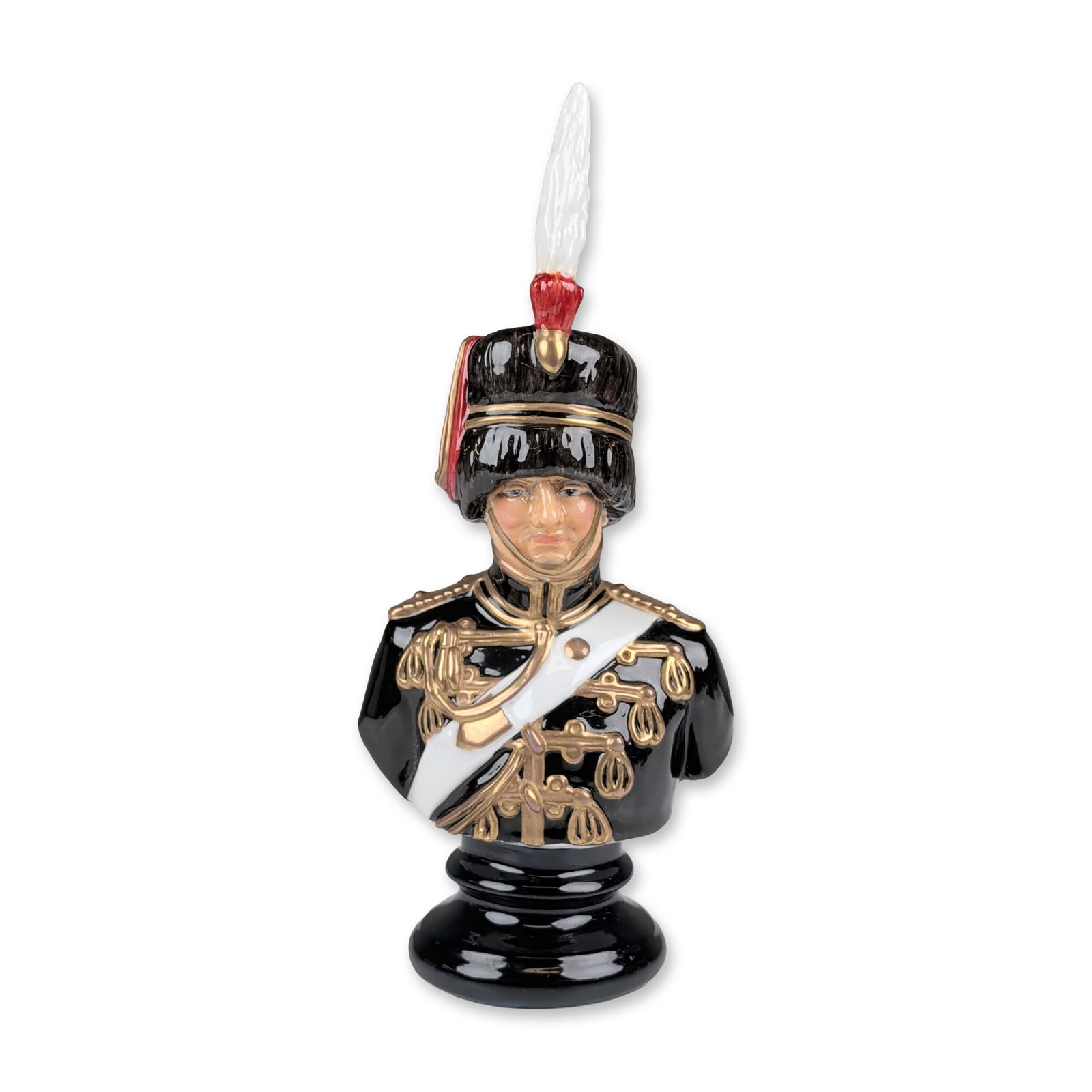 Michael Sutty Limited Edition Fine Bone China Military Bust: Fine china polychrome bust depicting a military officer. The figure is modeled wearing a black fur busby featuring a red bag and tall white plume, and a black dolman uniform with elaborate gilt-colore