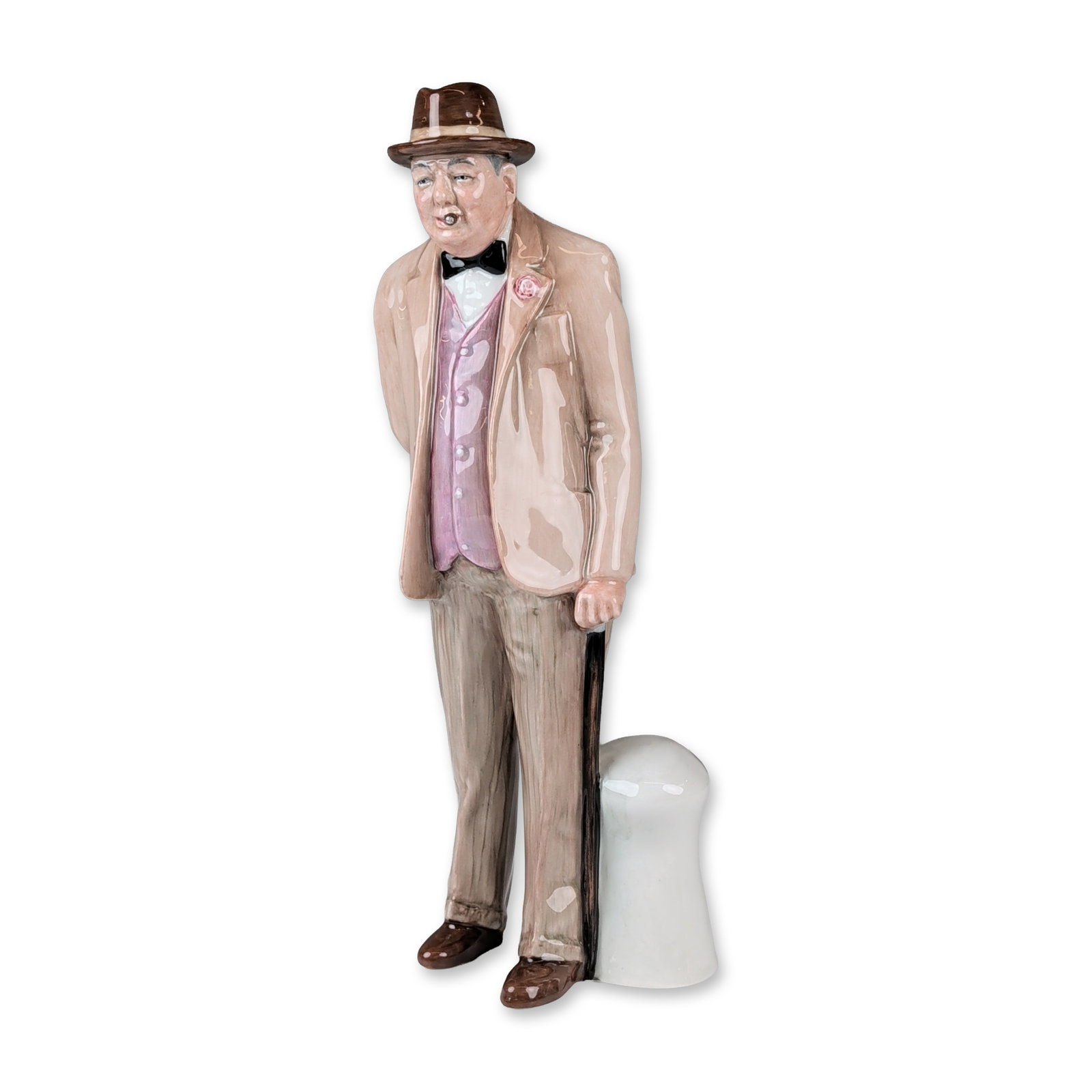 Royal Doulton Colorway Porcelain Figurine, Sir Winston Churchill HN3057: The hand-painted figure depicts the subject in characteristic civilian attire, including a tan suit, pink waistcoat, and brown homburg hat, standing next to a white pedestal. Details include a cigar s