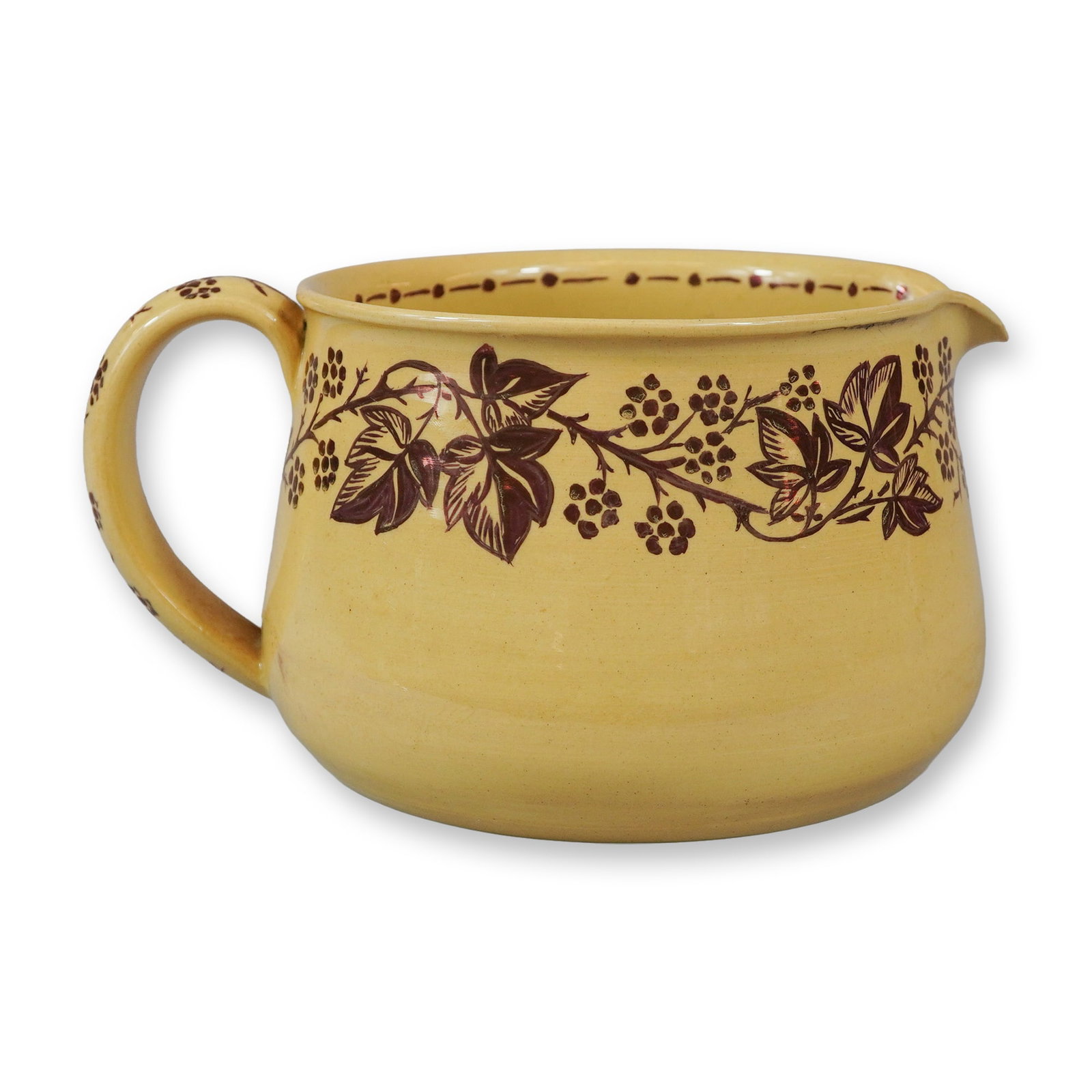 Signed Wedgwood Glazed Caneware Squat Pitcher: A late 19th-century Wedgwood glazed earthenware squat pitcher or milk jug. The vessel is crafted in pale yellow caneware with a wide, rounded form and a small pouring spout. The exterior is decorated 