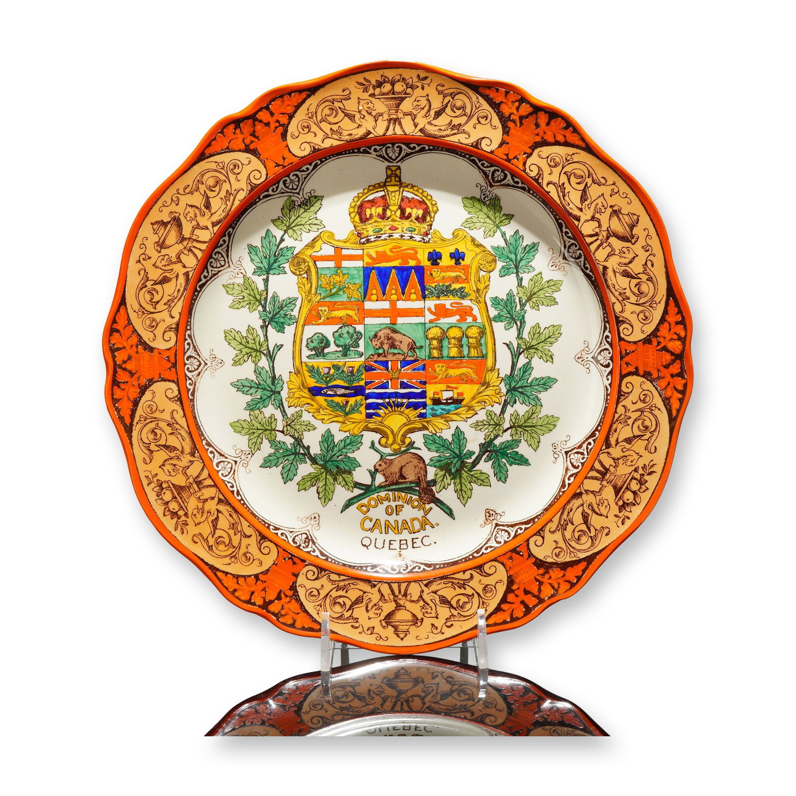 Wedgwood Etruria Earthenware Commemorative Plate, Dominion of Canada Coat of Arms: Decorated in a combination of hand painting and transfer printing. The central reserve features the Dominion of Canada Coat of Arms, rendered with detailed heraldic elements and enclosed within an orn