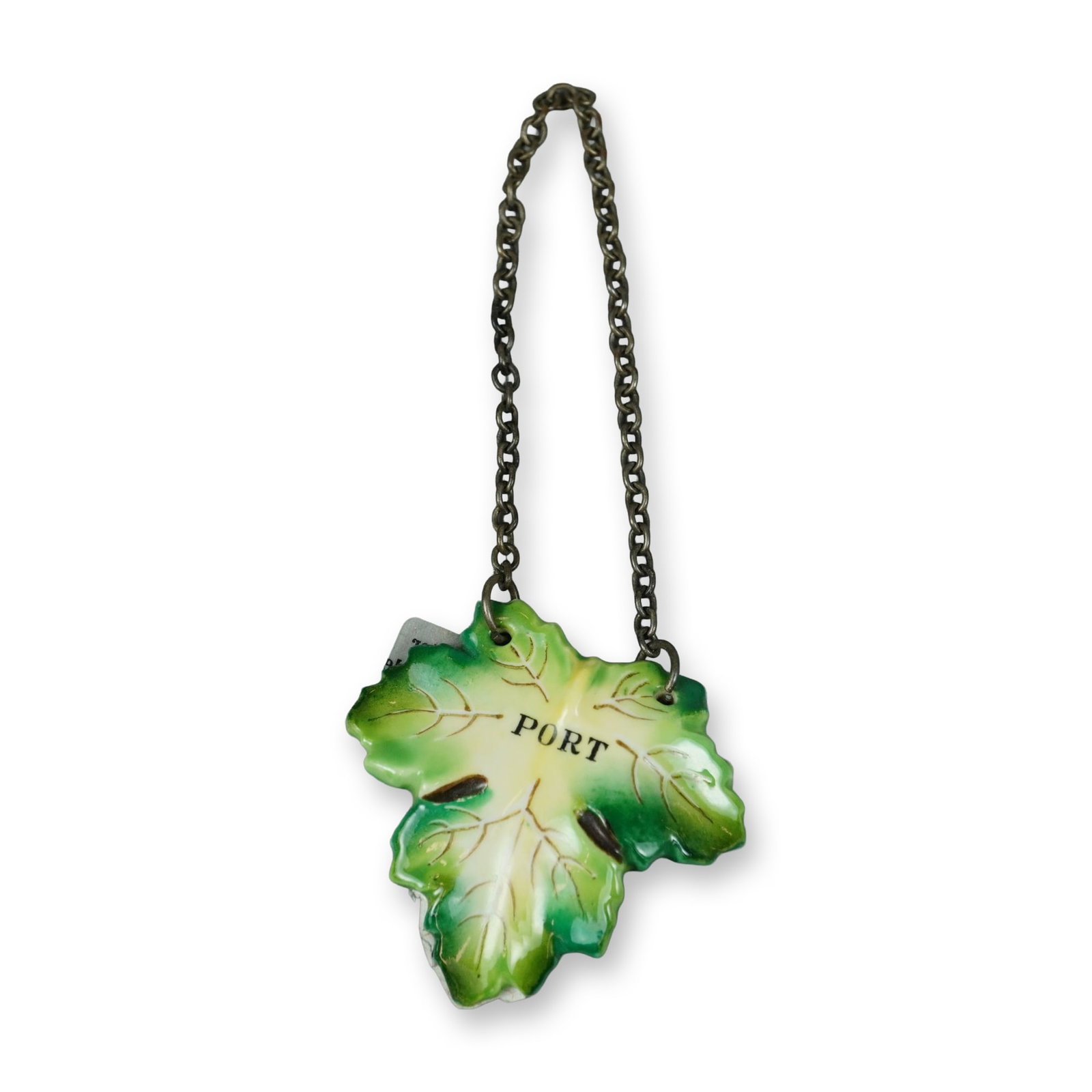 Wedgwood Bone China Port Decanter Label for T. Goode and Co: A Wedgwood bone china decanter label, also known as a bottle ticket, modeled in the form of a serrated vine leaf. The piece features hand-painted polychrome enamel decoration in shades of green and ye