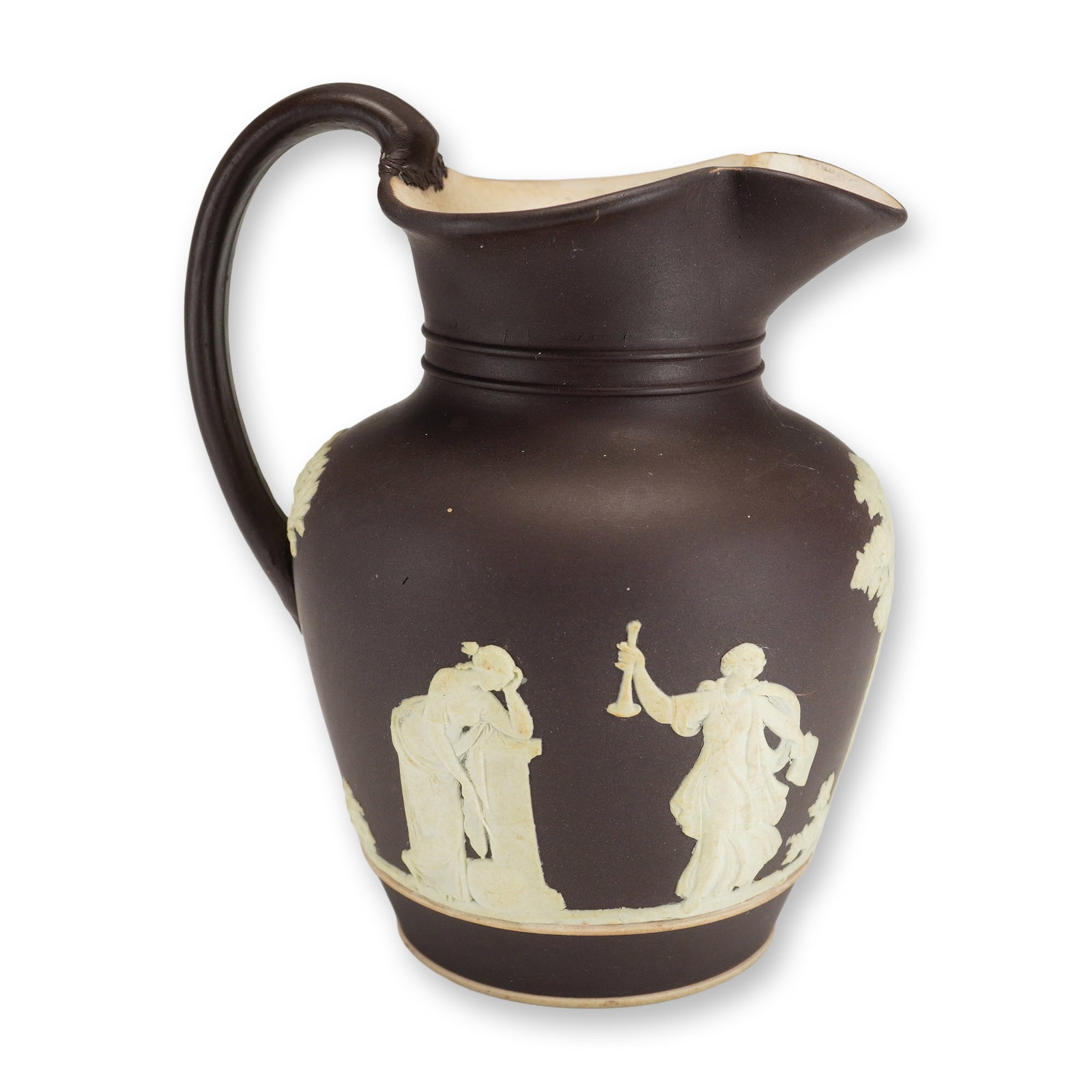 Wedgwood Chocolate Brown Jasperware Portland Vase Jug, c. 1875: This Wedgwood Jasperware jug is finished in a dark chocolate brown dip with white sprigged bas-relief decoration. The exterior is ornamented with figures from the Portland Vase pattern, depicting vari
