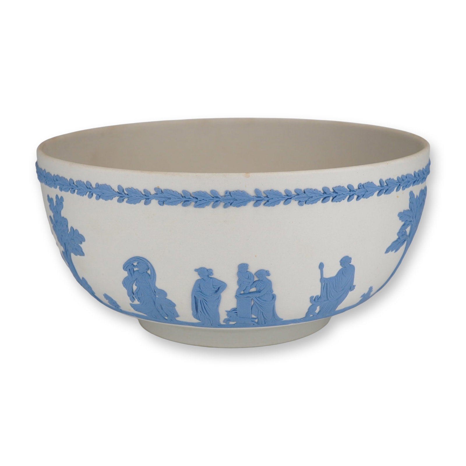 Wedgwood Blue and White Jasperware Sacrifice Pattern Bowl: A large Wedgwood jasperware bowl crafted in white matte stoneware with applied blue bas-relief sprigged decoration. The exterior displays a continuous frieze known as the Sacrifice pattern, featuring 