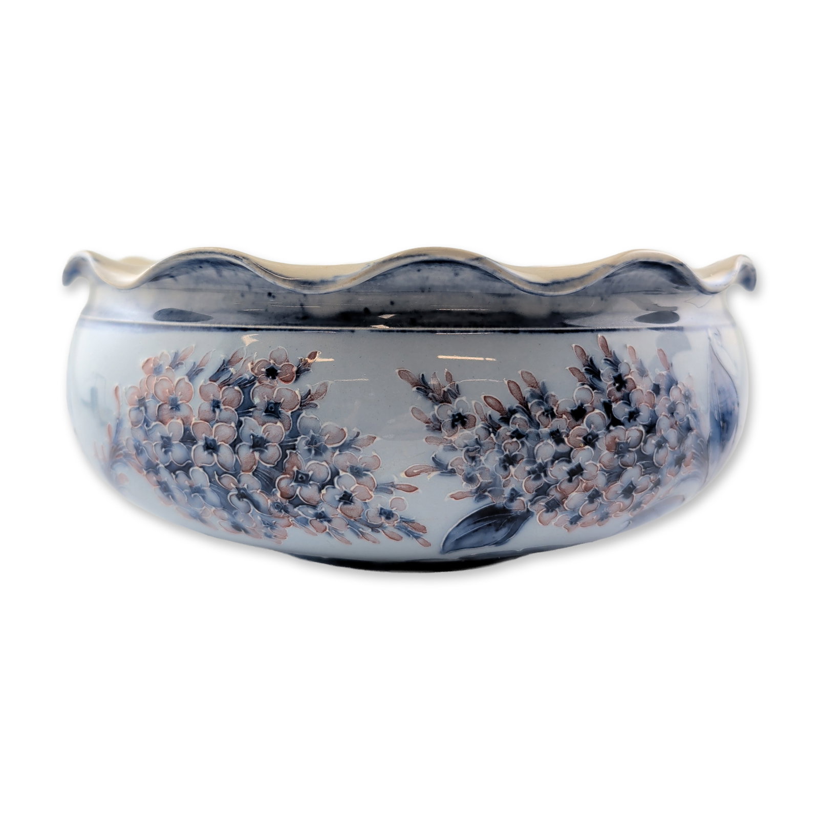 Moorcroft Macintyre Rare Florian Ware Lilac Bowl: The circular form features a prominent scalloped rim and a raised foot ring. The exterior is hand-decorated using a tube-lining technique with clusters of small flowers and large, sweeping foliate mot