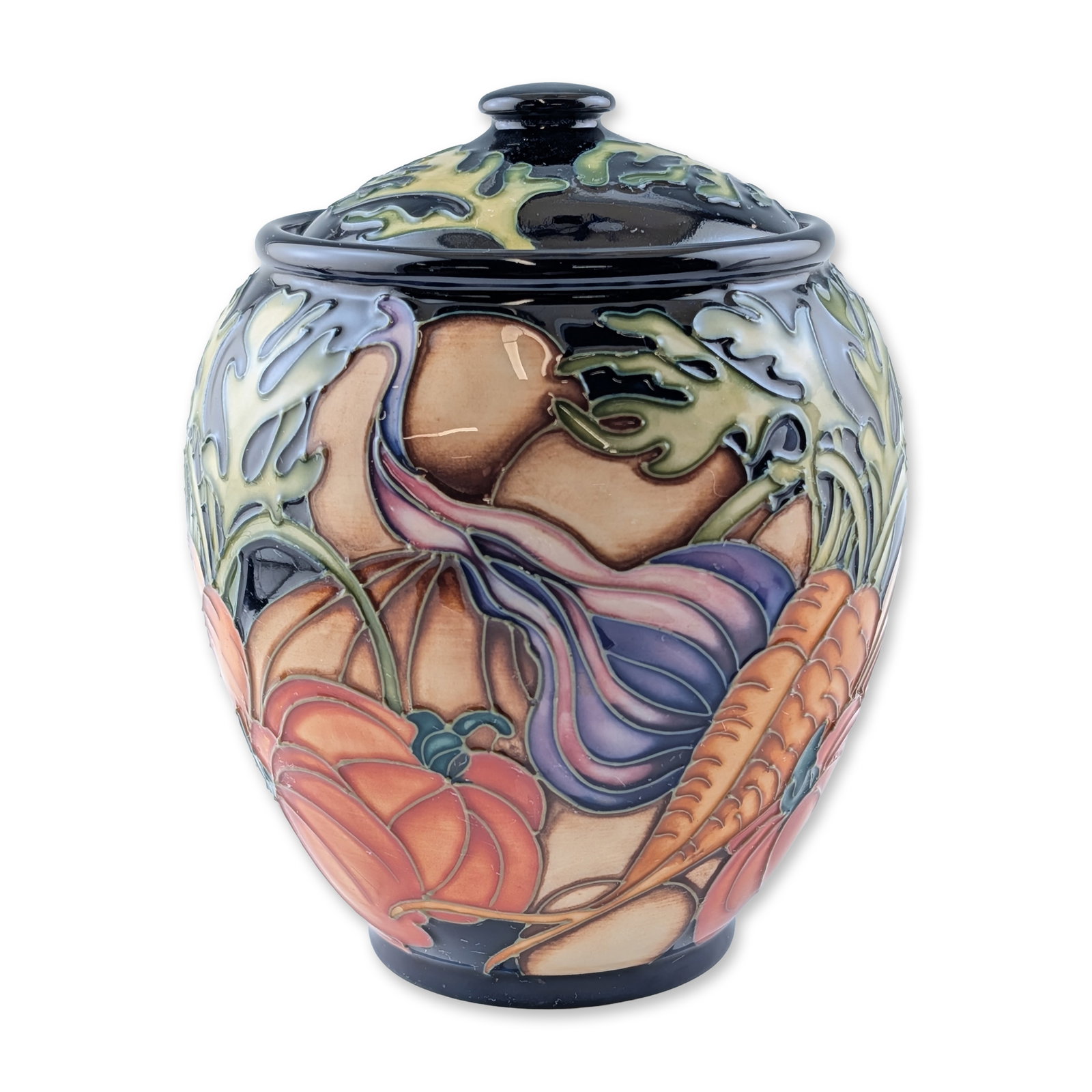 Moorcroft Pottery by Kerry Goodwin Lidded Jar, Vegetable Patch: The bulbous vessel features tube-lined decoration in the Vegetable Patch pattern, depicting pumpkins, carrots, and gourds in orange, purple, and cream tones against a black ground. The matching fitted