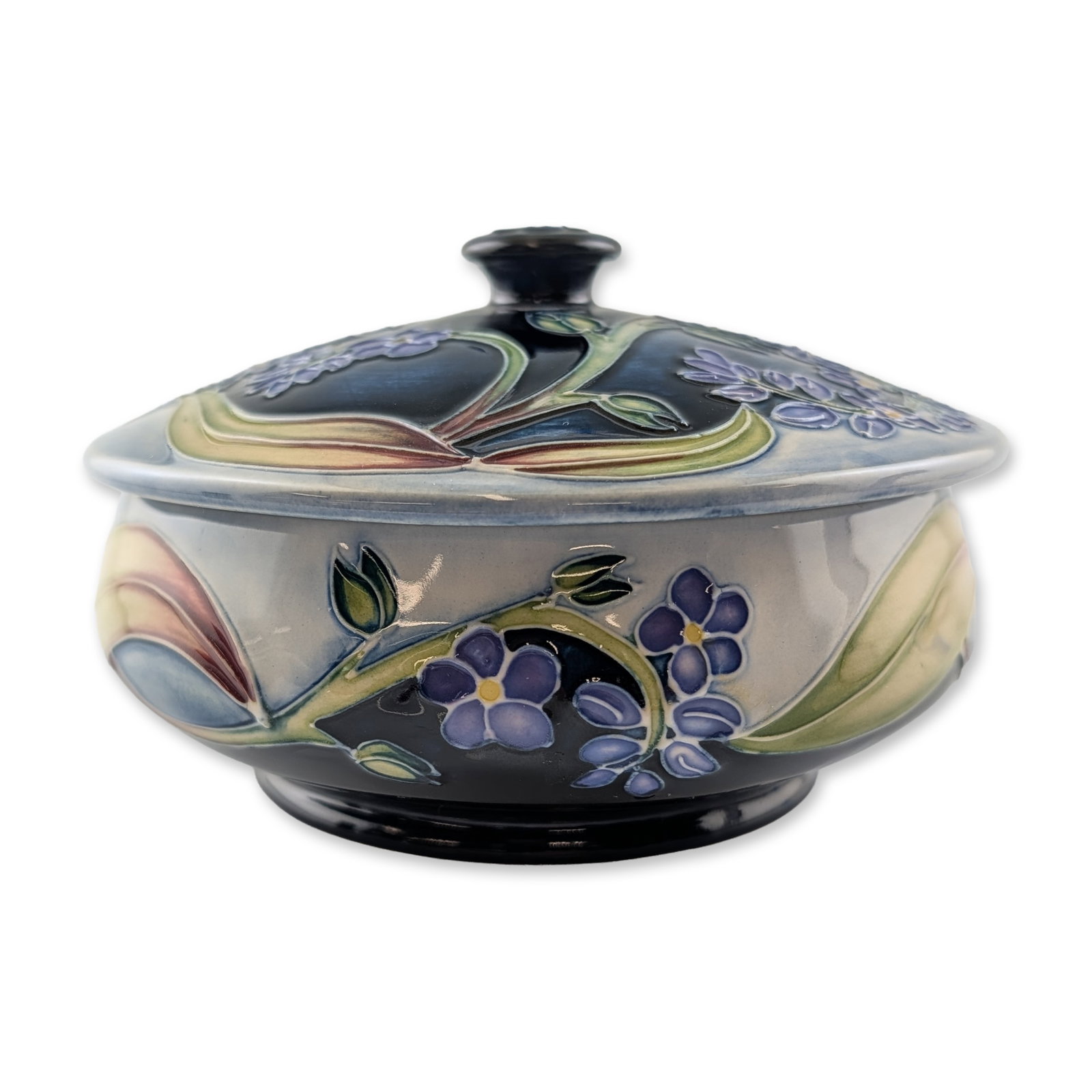 Moorcroft Pottery by Sian Leeper DMH Floral Motif Bowl: Limited edition. A low circular earthenware bowl designed by Sian Leeper for the Douglas Macmillan Hospice (DMH) charity edition. The vessel features tube-lined floral decoration depicting five-petale