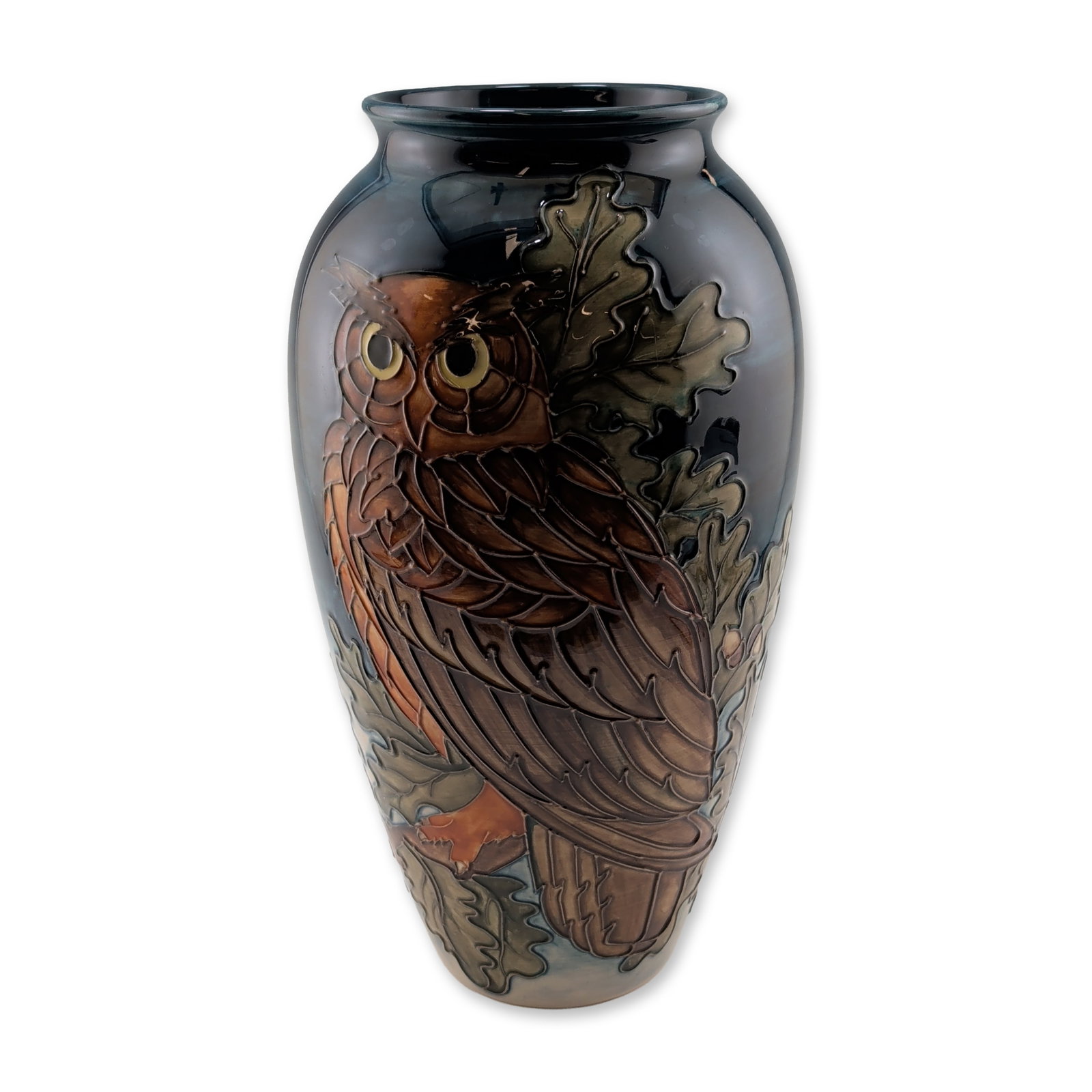 Moorcroft Pottery by Sally Tuffin Vase, Eagle Owl: Limited edition. The ovoid form features hand-decorated tube-lining and underglaze colors with a high-gloss finish. Decoration includes a large owl perched among oak leaves and a crescent moon set aga