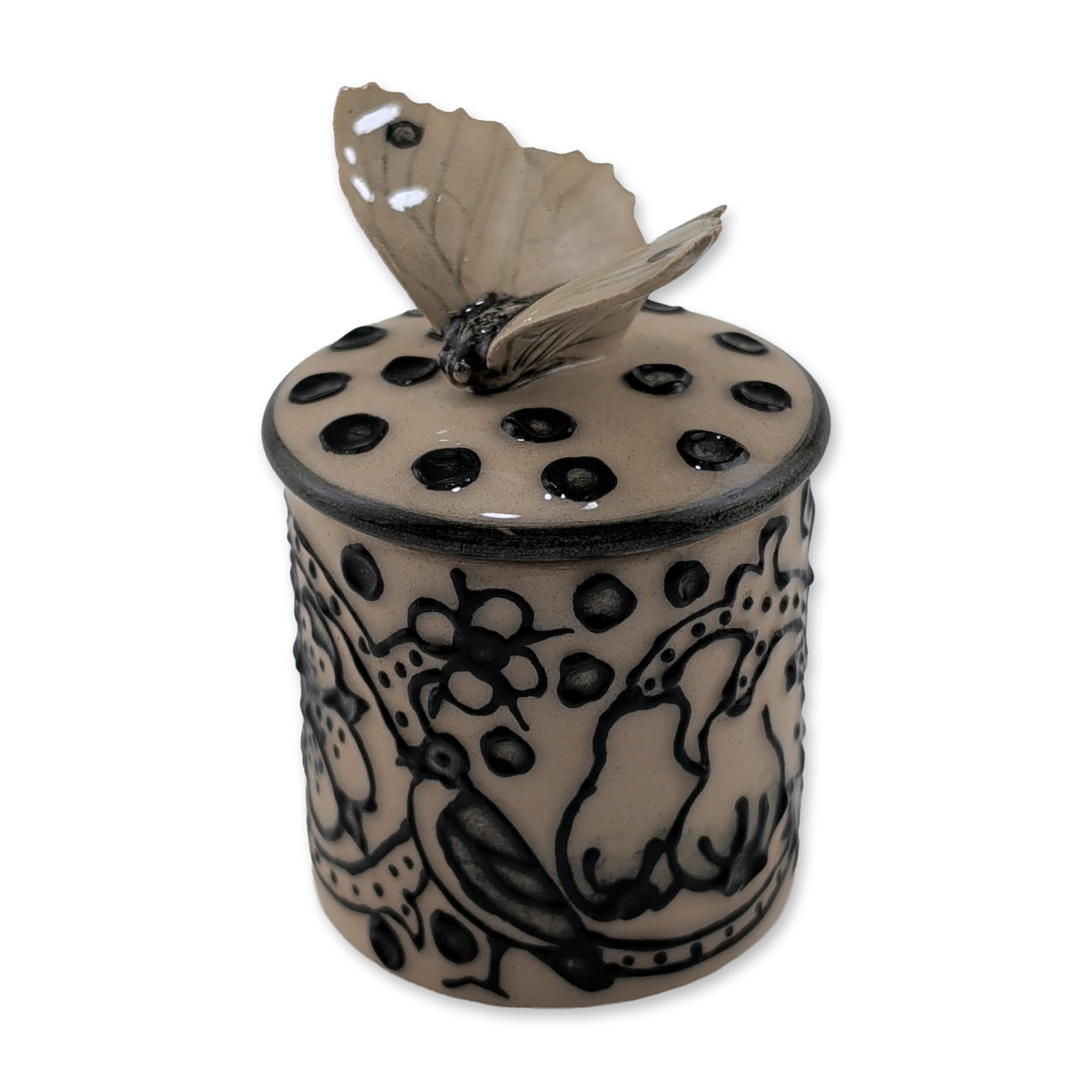 Dennis Chinaworks by Sally Tuffin Miniature Butterfly Lidded Jar, Elizabethan Embroidery: The piece features a cream-colored glaze decorated with raised black slip-trailed motifs including stylized flowers, fruits, animals, scrolls, and dots. The lid is topped with a molded butterfly finia