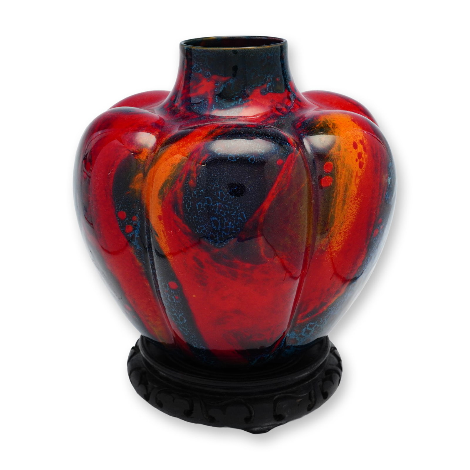 Royal Doulton Sung Flambe Pumpkin Vase with Base: A pumpkin-form vase finished in a red fired glaze, accented with blue and yellow mottled hues. Includes a base. Royal Doulton Flambe backstamp and Sung mark present. No. 503. Dimensions: Vase only: 8.