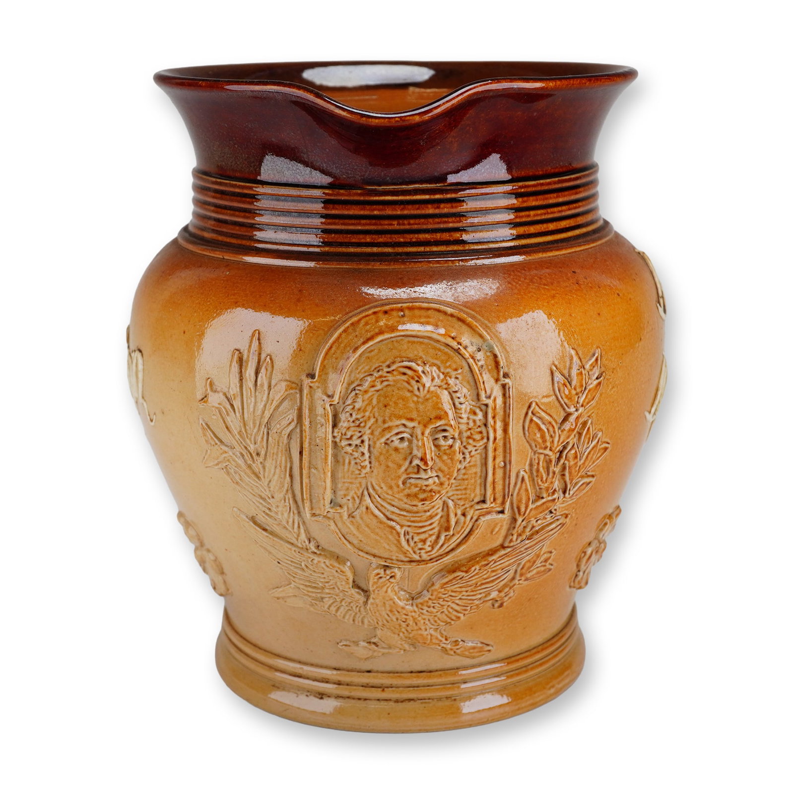 Doulton Lambeth Stoneware George Washington Jug: Salt-glazed in two tones of brown, this piece features a molded portrait relief of George Washington, framed by an eagle with olive and wheat branches. One side is inscribed in relief: "George Washing