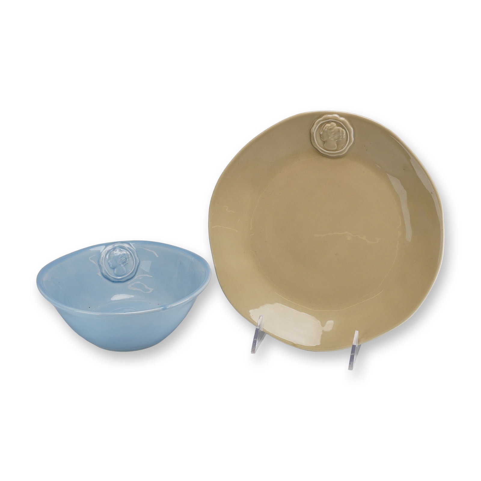 Two Wedgwood Portobello Road Glazed Ceramic Tableware - Bowl & Plate: The set consists of one deep round bowl finished in a light blue glaze and one flat dinner plate in a tan or khaki glaze. Both items exhibit a slightly irregular, hand-formed shape and are decorated w
