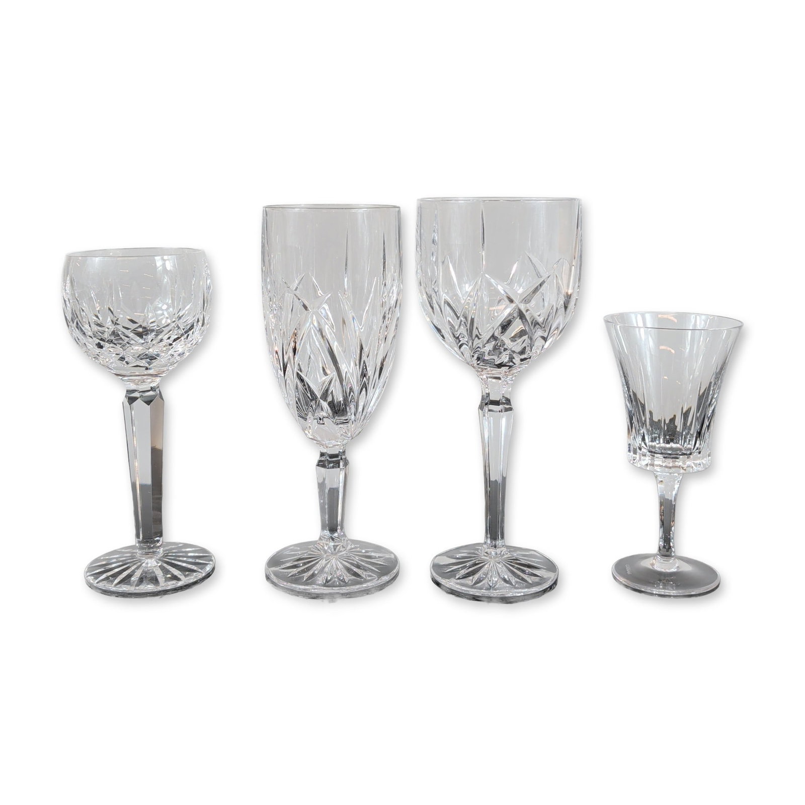 Group of Four Marquis by Waterford and Gorham Crystal Stemware: Marquis by Waterford and Gorham. Group of four stemware pieces in lead crystal, featuring assorted cut patterns including Brookside and Hanover styles. One flared port glass by Gorham displays vertica