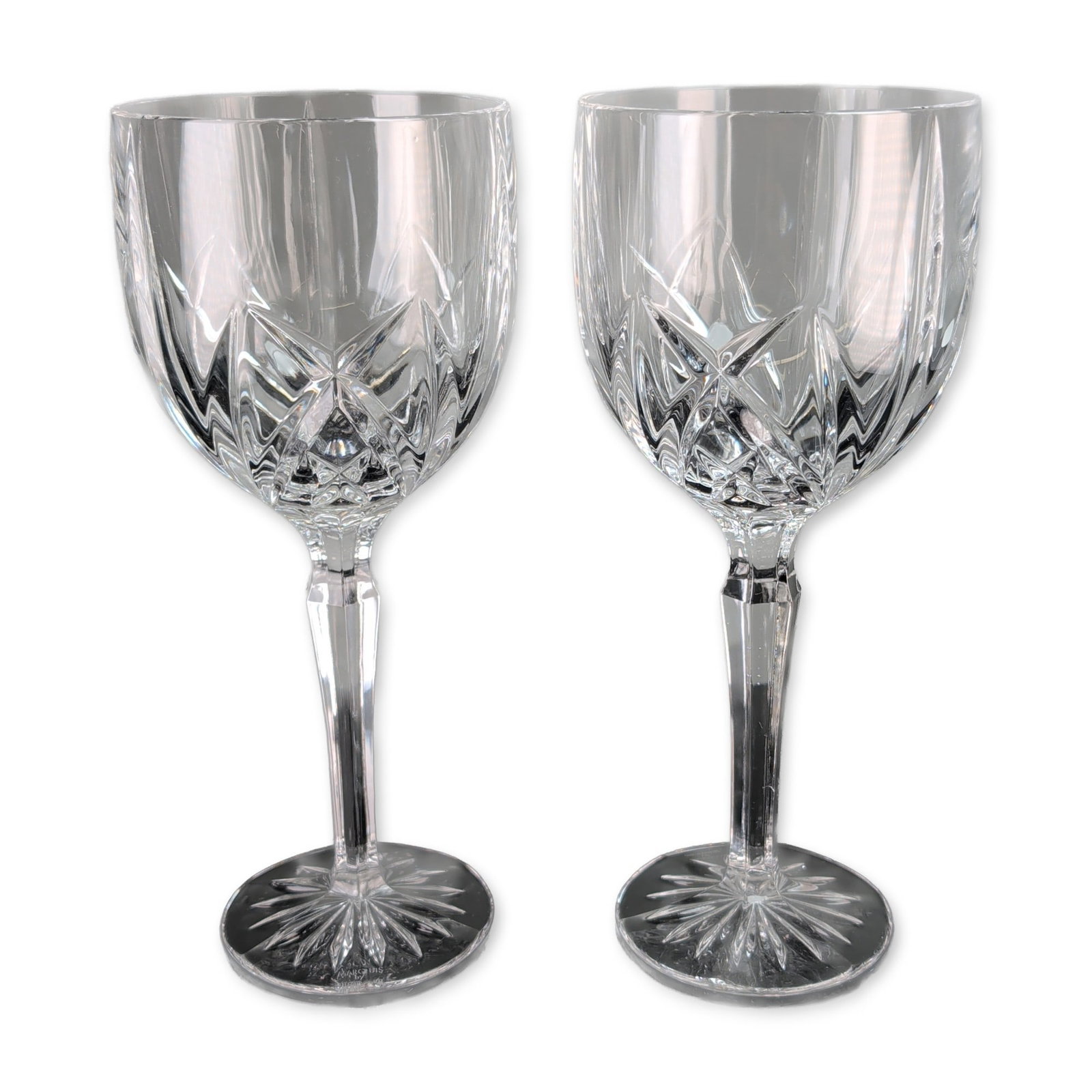 Pair of Marquis by Waterford Brookside Wine Goblets: Marquis by Waterford. Pair of wine goblets in the Brookside pattern, crafted in cut crystal. The design features vertical linear cuts on the upper bowl transitioning into a geometric diamond and wedge