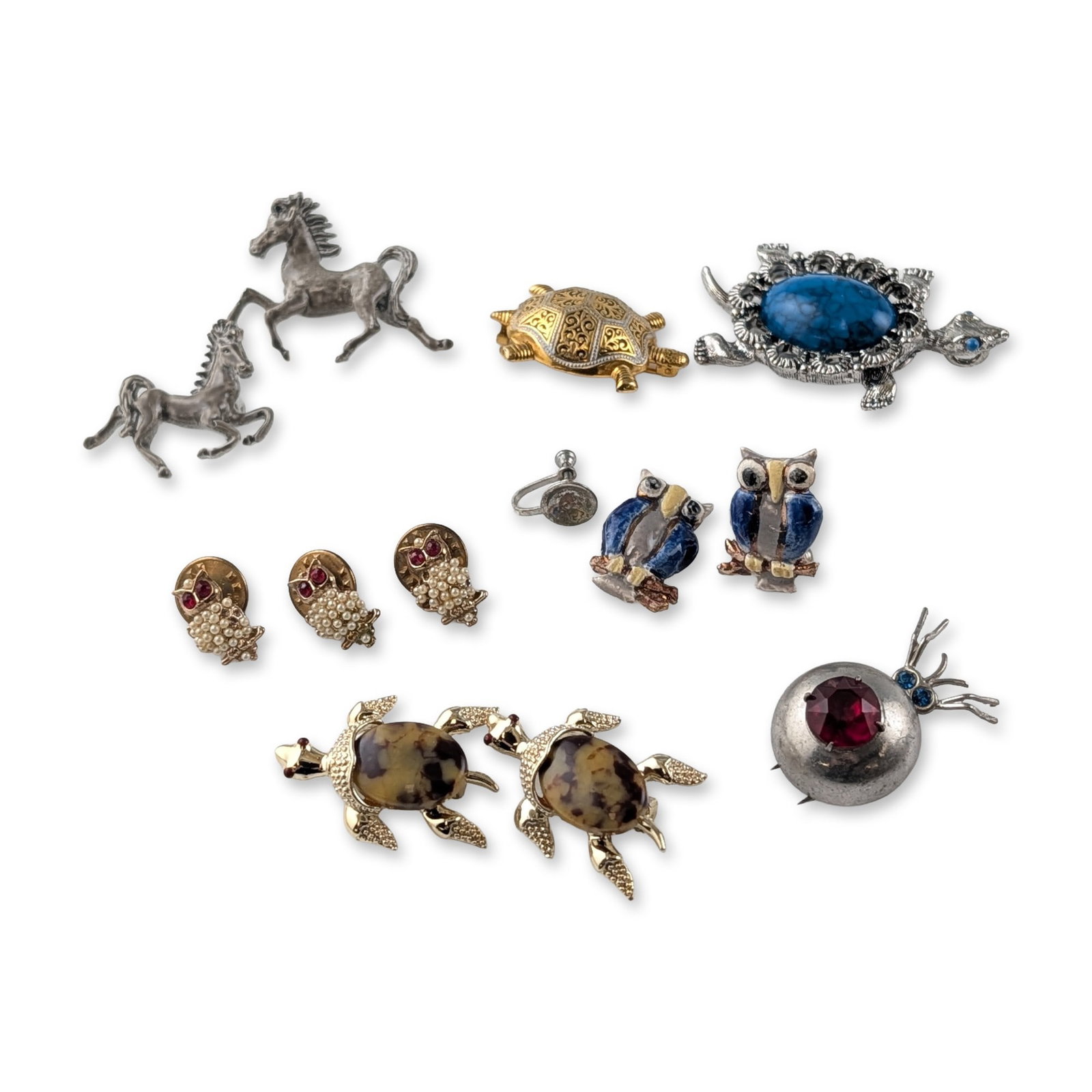 12pc Vintage Animal Motif Costume Jewelry Earrings, Brooches and Pins: Vintage animal motif costume jewelry collection featuring pieces by Gerrys and Swank. The assortment includes a silver-tone turtle brooch with a blue mottled cabochon and rhinestone eyes, marked Gerry