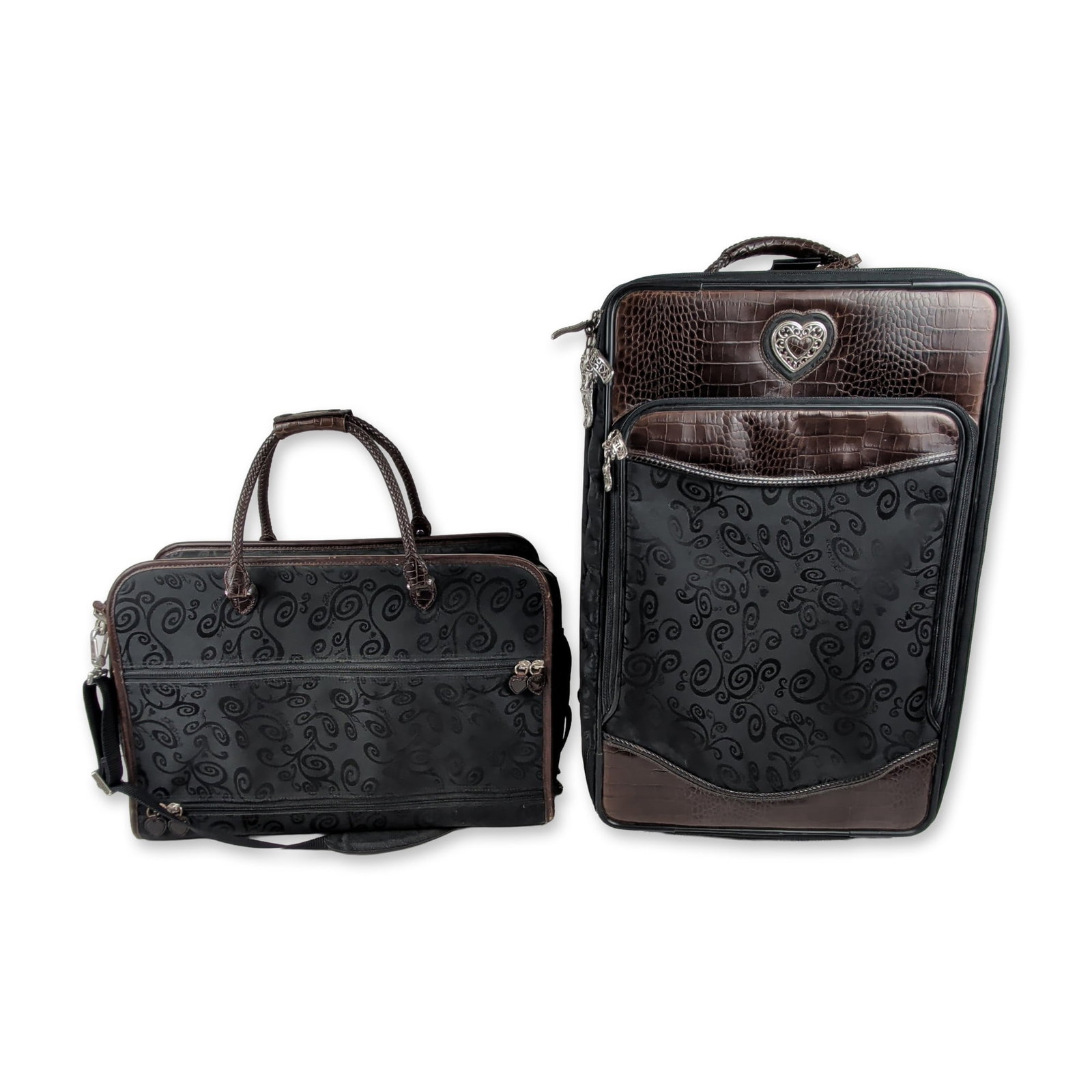 Brighton Two-Piece Scroll Pattern Luggage Set: Brighton two-piece luggage set consisting of a wheeled carry-on suitcase and a matching overnight tote bag. Exterior is constructed from black textile featuring a tonal embossed scroll motif and choco