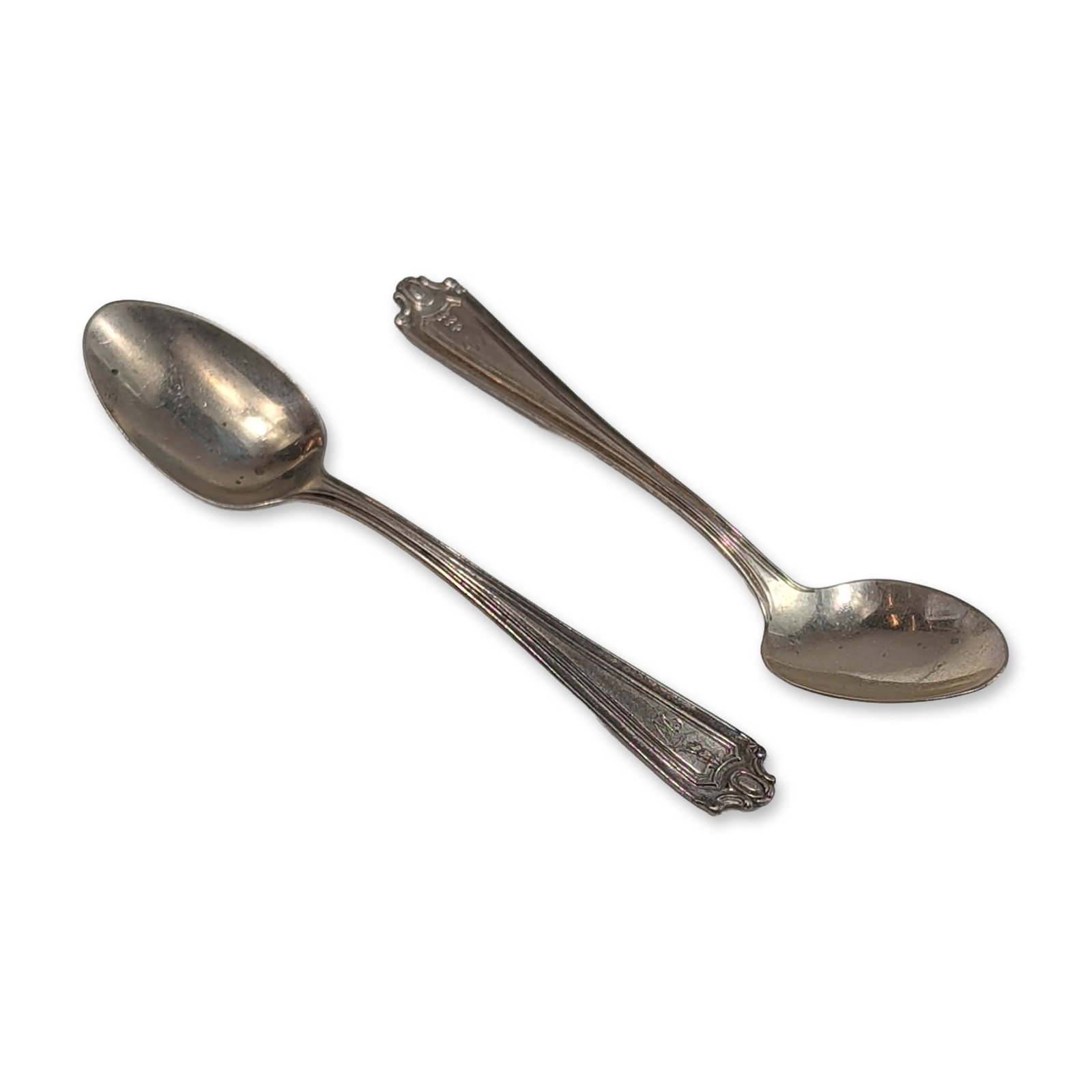 Pair of Lunt Sterling Silver Demitasse Spoons: Pair of sterling silver demitasse spoons featuring decorative scrolled shell terminals and fluted shafts tapering to elongated oval bowls. Reverse of each handle is stamped with the mark STERLING.