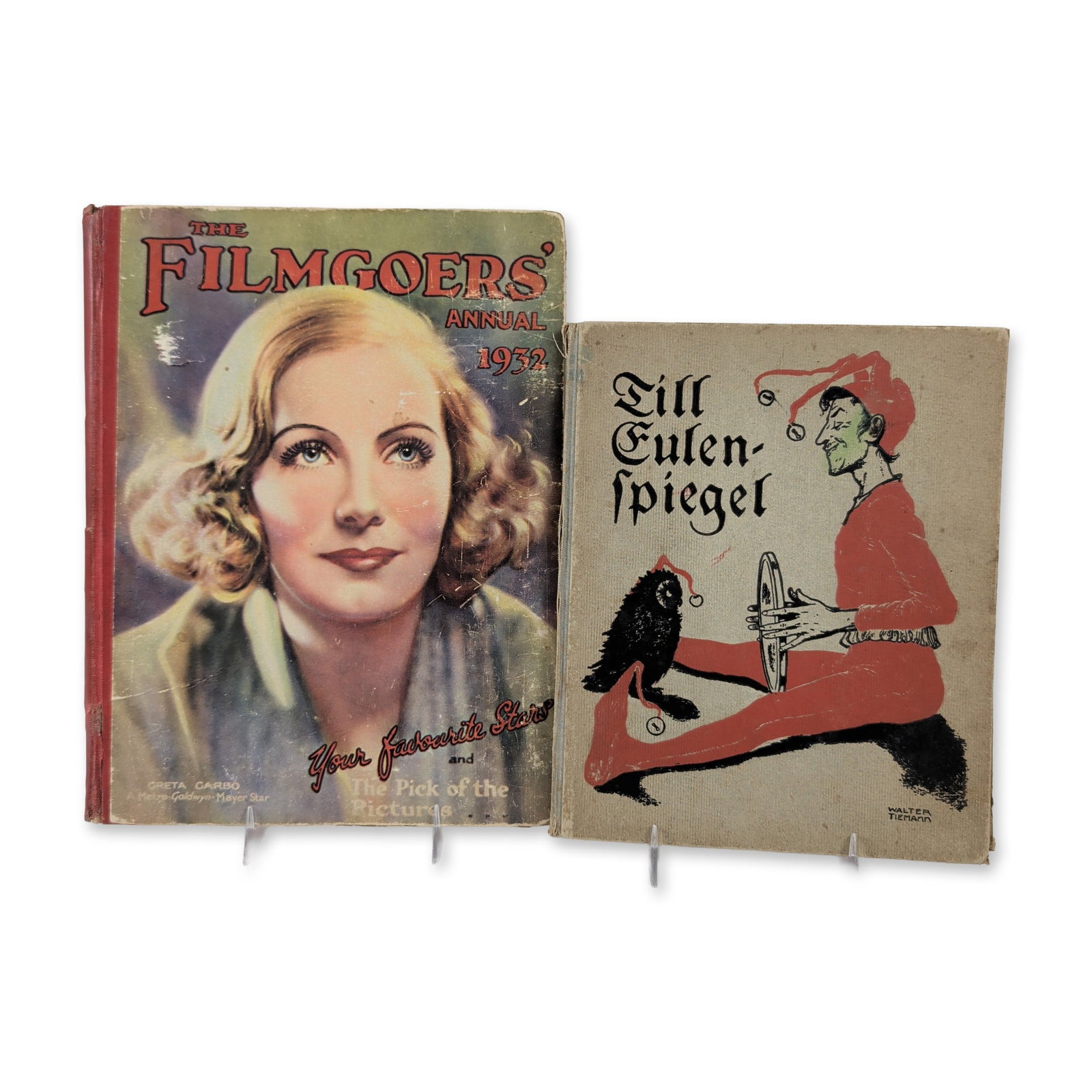 2 German Language Illustrated Books: Filmgoers Annual 1932 and Till Eulenspiegel: Two vintage hardcover volumes featuring cinema history and German folklore. The Filmgoers Annual 1932 features pictorial paper-covered boards with a portrait of Greta Garbo and a red cloth spine. The 