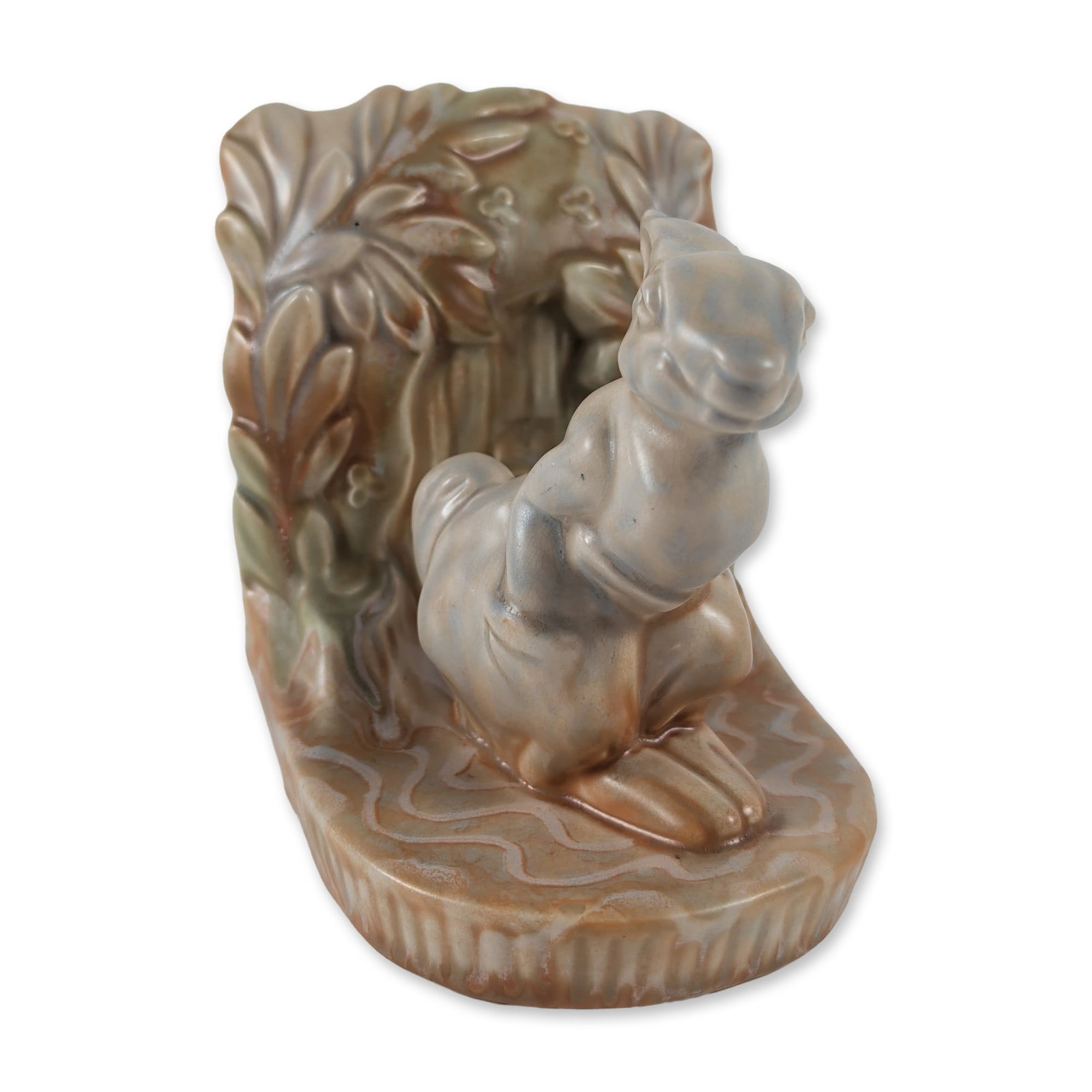 Beswick Ware Glazed Ceramic Rabbit Single Bookend: Beswick, England. Figural rabbit bookend in glazed ceramic, featuring a high-gloss variegated finish with mottled olive green, tan, and grey-blue tones. The figure is depicted standing in front of a f