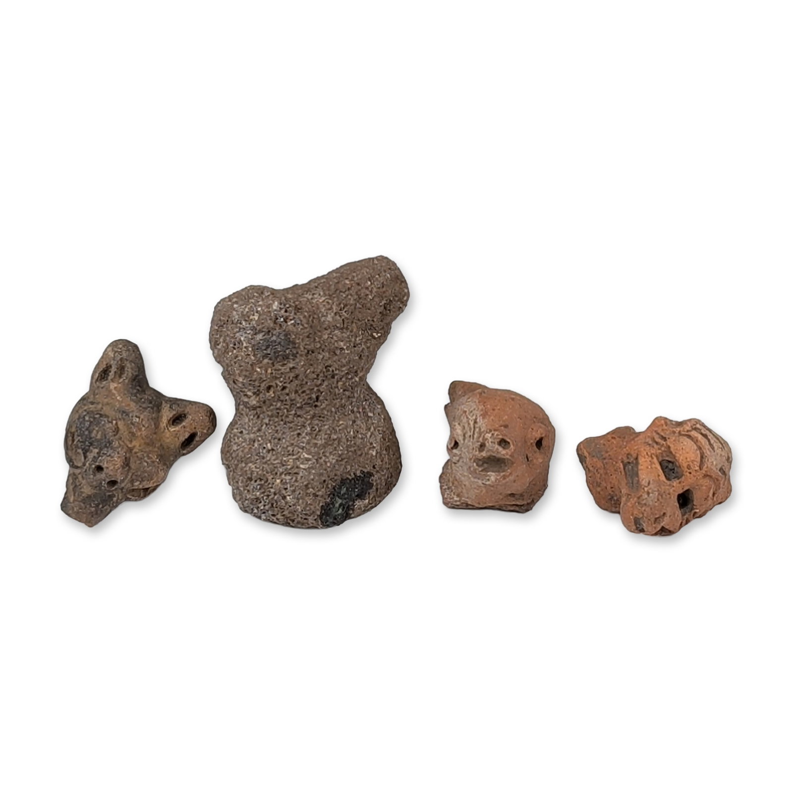 4pc Pre-Columbian Effigy Figurines: Group of four artifacts, including one carved vesicular volcanic stone effigy and three terracotta pottery fragments. The stone figure features a stylized hourglass form with a protruding head. The te