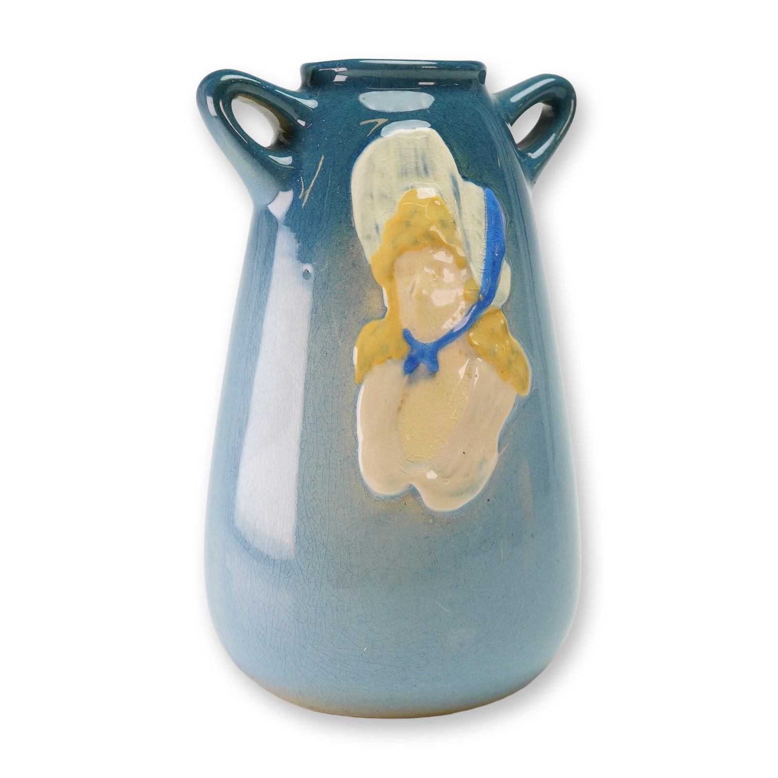 Weller Pottery Blue Vase, Dickens Ware: The vessel features a tapered body with two small loop handles at the neck. The exterior is finished in a blue gradient glaze. One side is decorated with a relief-molded figure of a person in a large 