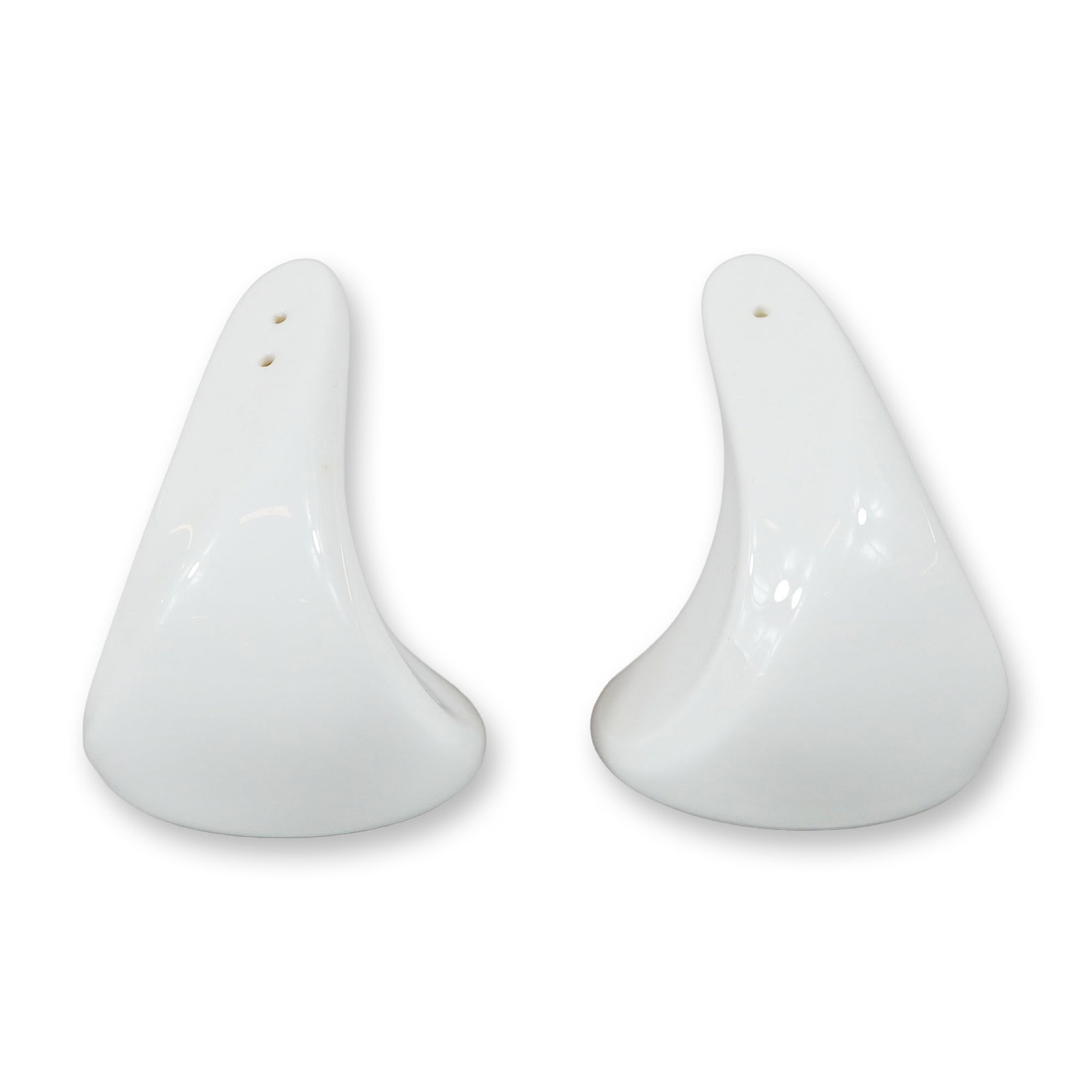 A Pair of Wedgwood Hotelware Salt and Pepper Shakers: A pair of white glazed ceramic salt and pepper shakers by Wedgwood. These pieces are part of the Wedgwood Hotelware collection and feature a distinct modernist, organic sculptural form with a swept-ba
