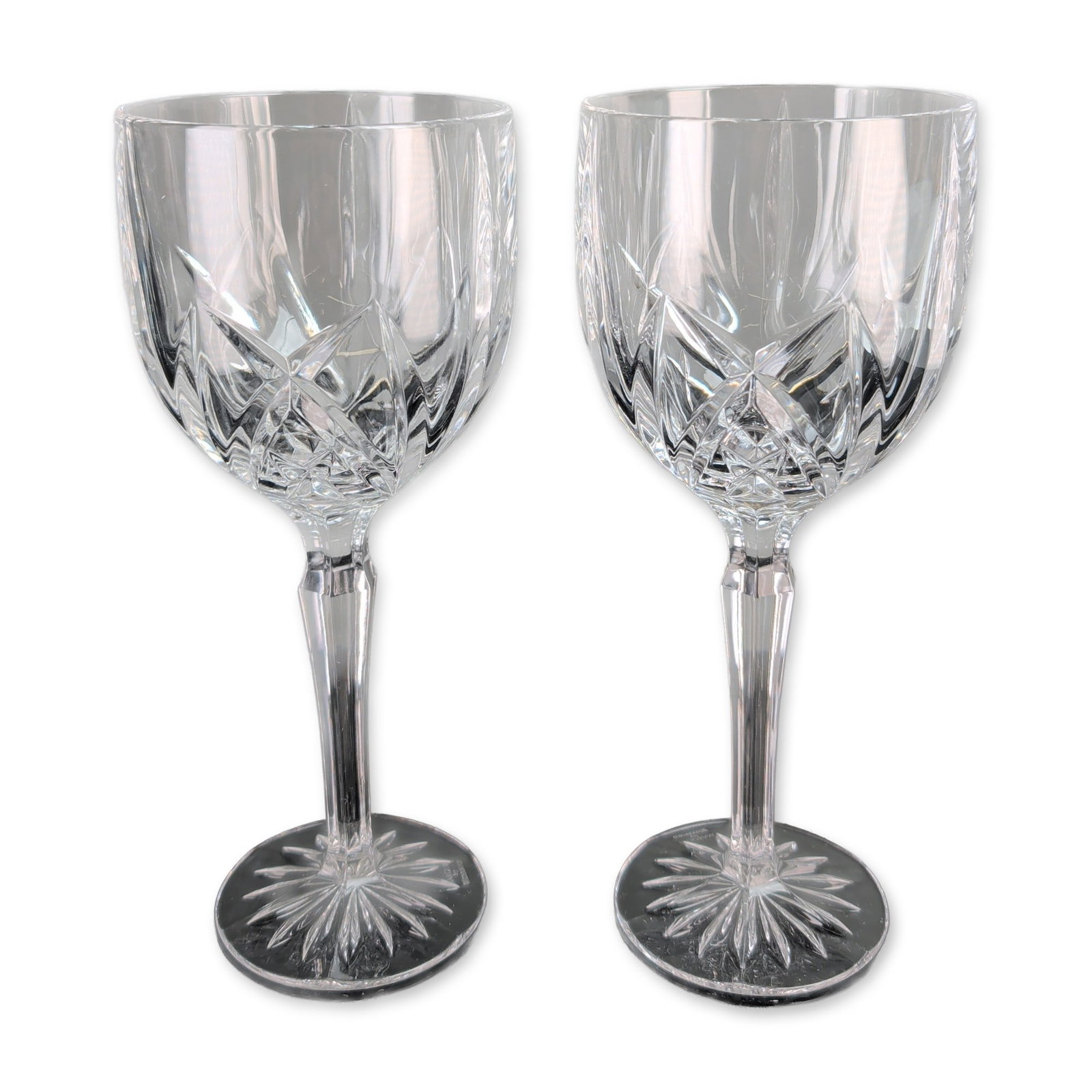 Pair of Marquis Waterford Brookside Crystal Goblets: Marquis by Waterford. Pair of wine goblets in clear crystal, featuring the Brookside pattern with deep-cut crisscross diamond and vertical wedge motifs. Each glass has a faceted hexagonal stem and a
