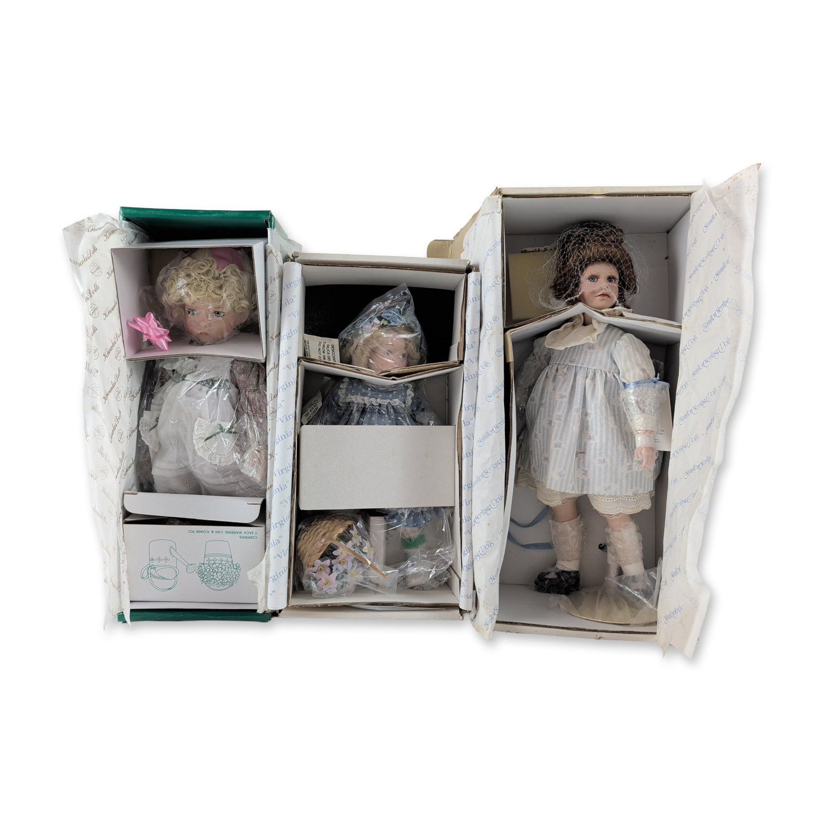 3pc Hamilton and Knowles Artist Series Porcelain Dolls: A collection of three artist-designed bisque porcelain dolls in their original packaging. The group includes Kelly sculpted by Jane Zidjunas for The Hamilton Collection, Virginia after Bessie Pease Gu