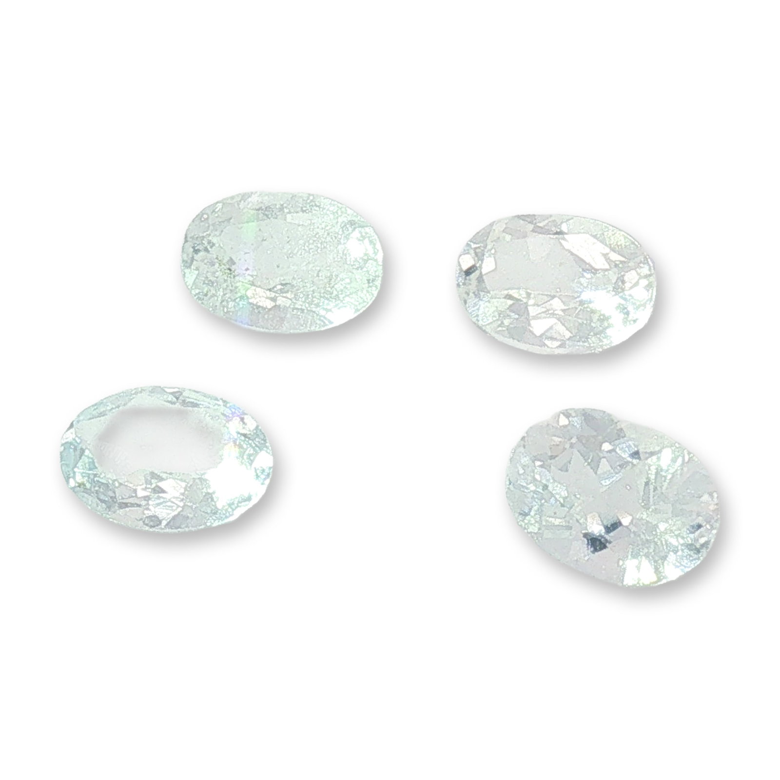4pc Collection of Loose White Topaz Gemstones: Collection of loose topaz gemstones. The unmounted stones appear to be colorless to near-colorless, with oval cuts. This grouping provides a versatile foundation for custom jewelry design and personal