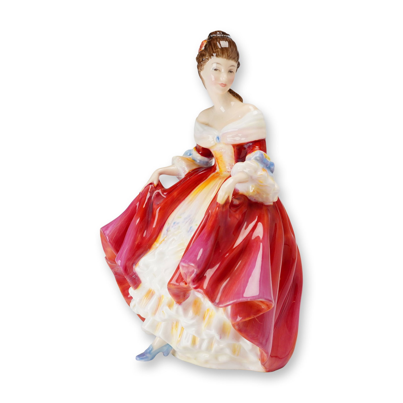 Royal Doulton Bone China Figurine, Southern Belle HN2229: Designed by Peggy Davies. Featuring a woman in mid-19th-century style dress with a red overskirt, orange and yellow bodice, and white ruffled petticoat, revealing a single light blue shoe. Base featur