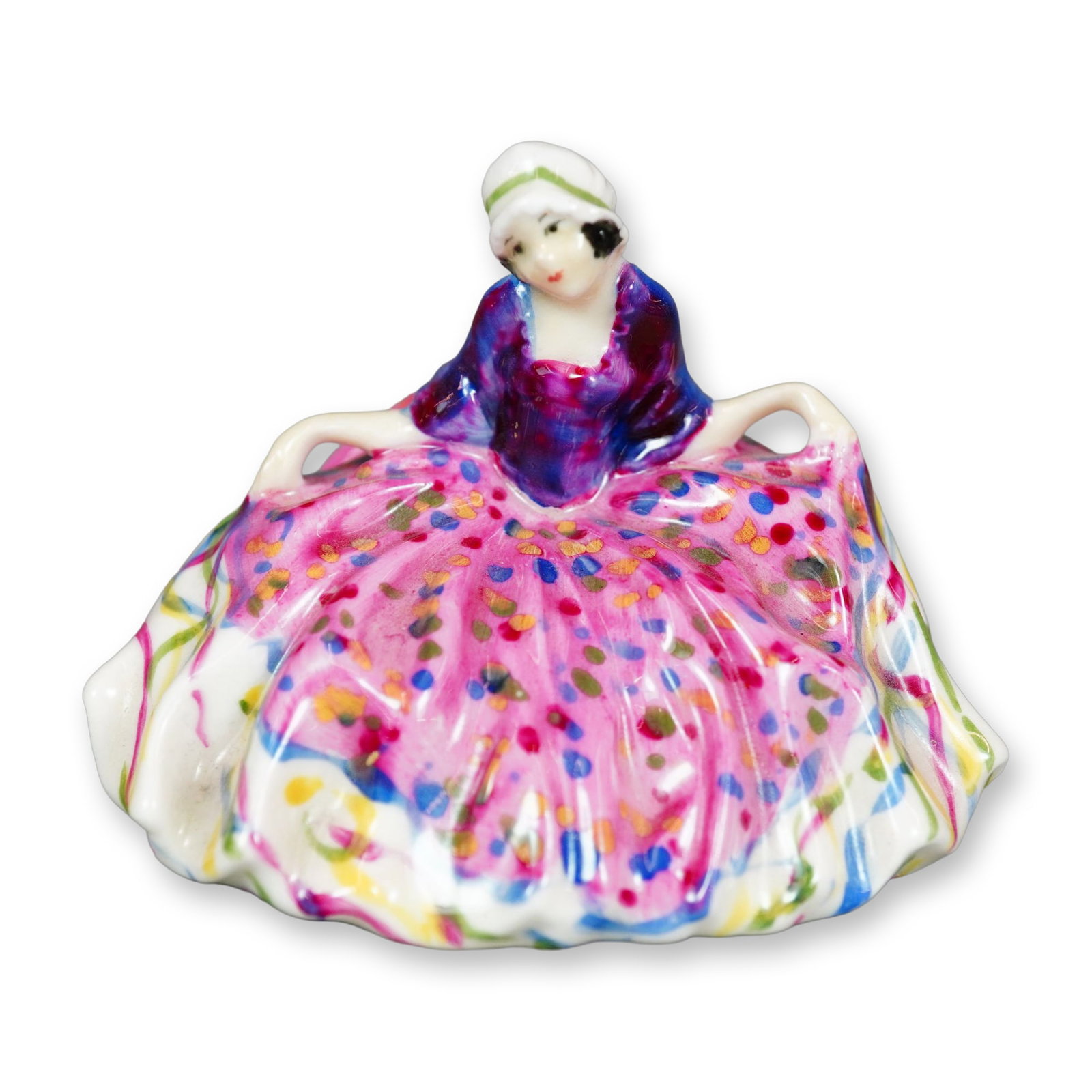 Royal Doulton Figurine, Polly Peachum M23: Inspired by the character from The Beggar's Opera, this Royal Doulton figure portrays a young woman in a graceful curtsy. She wears a pink gown accented with colorful polka dots and ribbon details. Ma