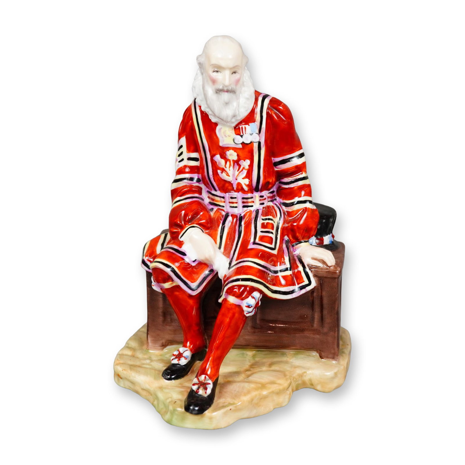 Royal Doulton Bone China Figurine, A Yeoman of the Guard HN2122: Hand painted figure of a seated English guard. He is wearing the traditionally red Yeoman uniform. Royal Doulton backstamp. Dimensions: 4"L x 3.75"W x 6"H Manufacturer or Brand: Royal Doulton Country 