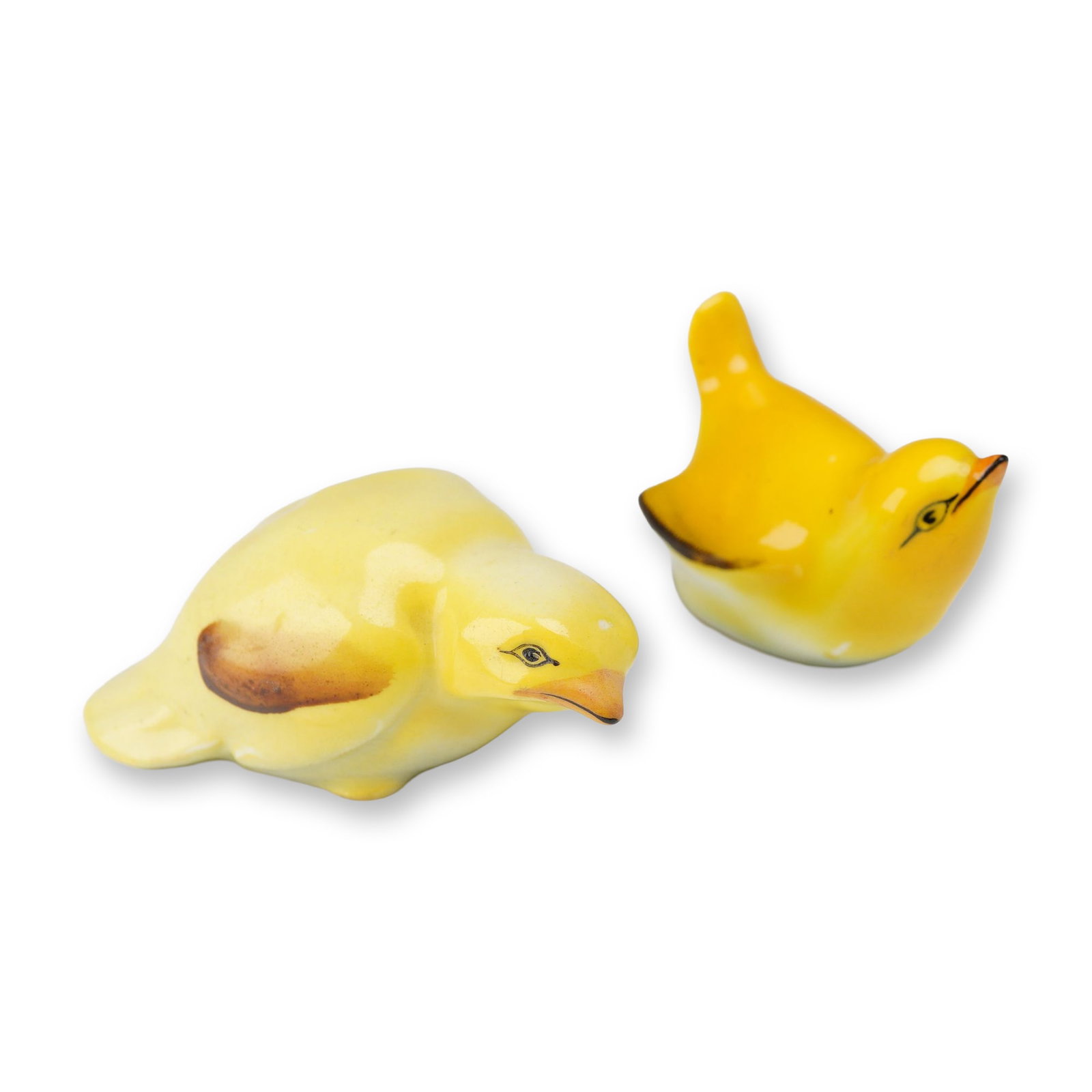 2pc of Royal Doulton Porcelain Bird Figurines, Fledgling: Pair of porcelain figurines modeled as small yellow birds. One figure is depicted in an upright, alert posture, while the second is in a forward-leaning, pecking pose. Both examples feature a vibrant 
