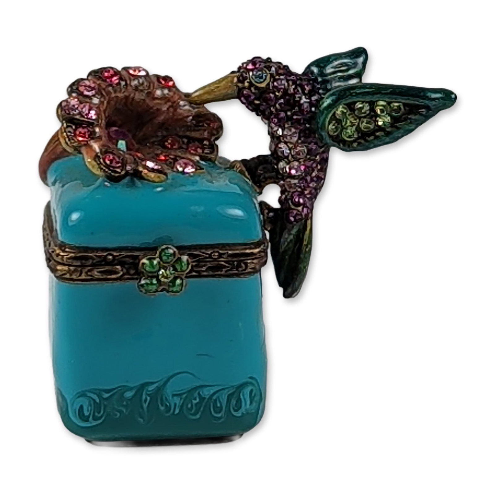 Jay Strongwater Enameled Hummingbird Trinket Box: Jay Strongwater miniature trinket box in hand-enameled metal, featuring a hummingbird figure set with multi-colored crystals in shades of purple, green, and pink. The bird is positioned over a floral 