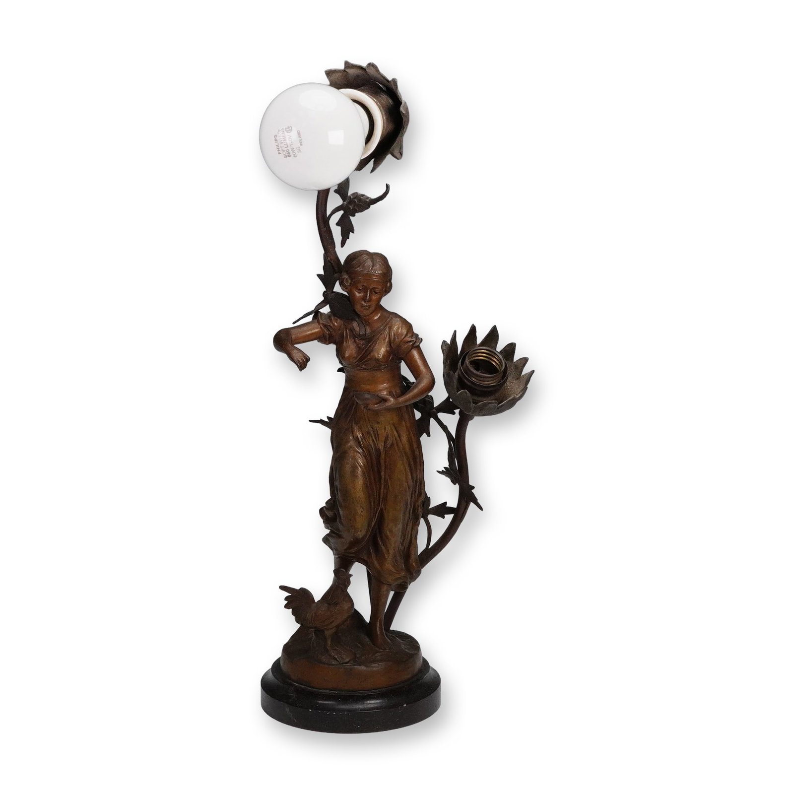 Figural Bronze-Tone Table Lamp with Floral Sockets on Marble Base: A decorative figural table lamp featuring a bronze-tone cast metal sculpture of a young woman in flowing dress with a rooster at her feet. Two floral form light sockets extend from leafy stems rising 