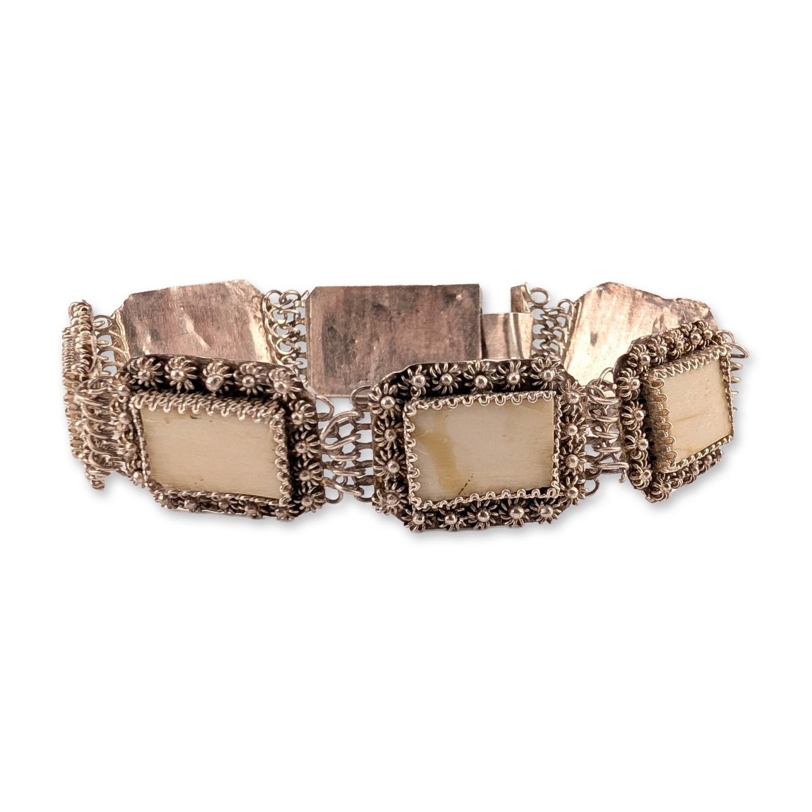 Vintage Asian Style 970 Silver Filigree and Bone Panel Bracelet: Asian style link bracelet featuring six rectangular panels in silver. Each panel contains a cream-colored plaque inlay, likely bone, set within wide borders of ornate filigree wirework and granulated 