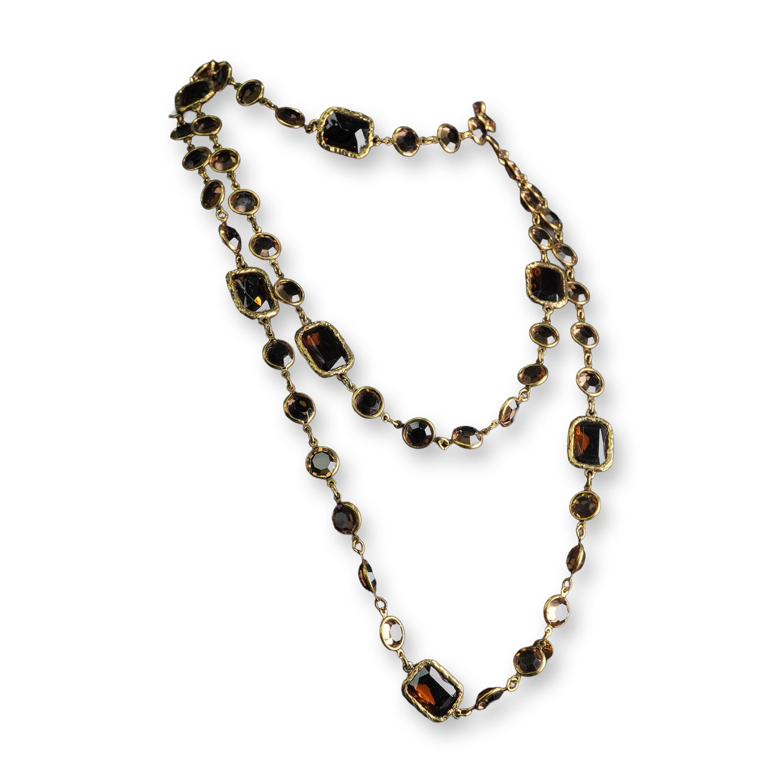 Chanel 1981 Chicklet Station Necklace, Amber Brown: Chanel 1981 Chicklet station necklace, crafted from gold-plated metal, featuring numerous faceted stones in various shades of brown. The necklace design alternates between round and rectangular/cushio