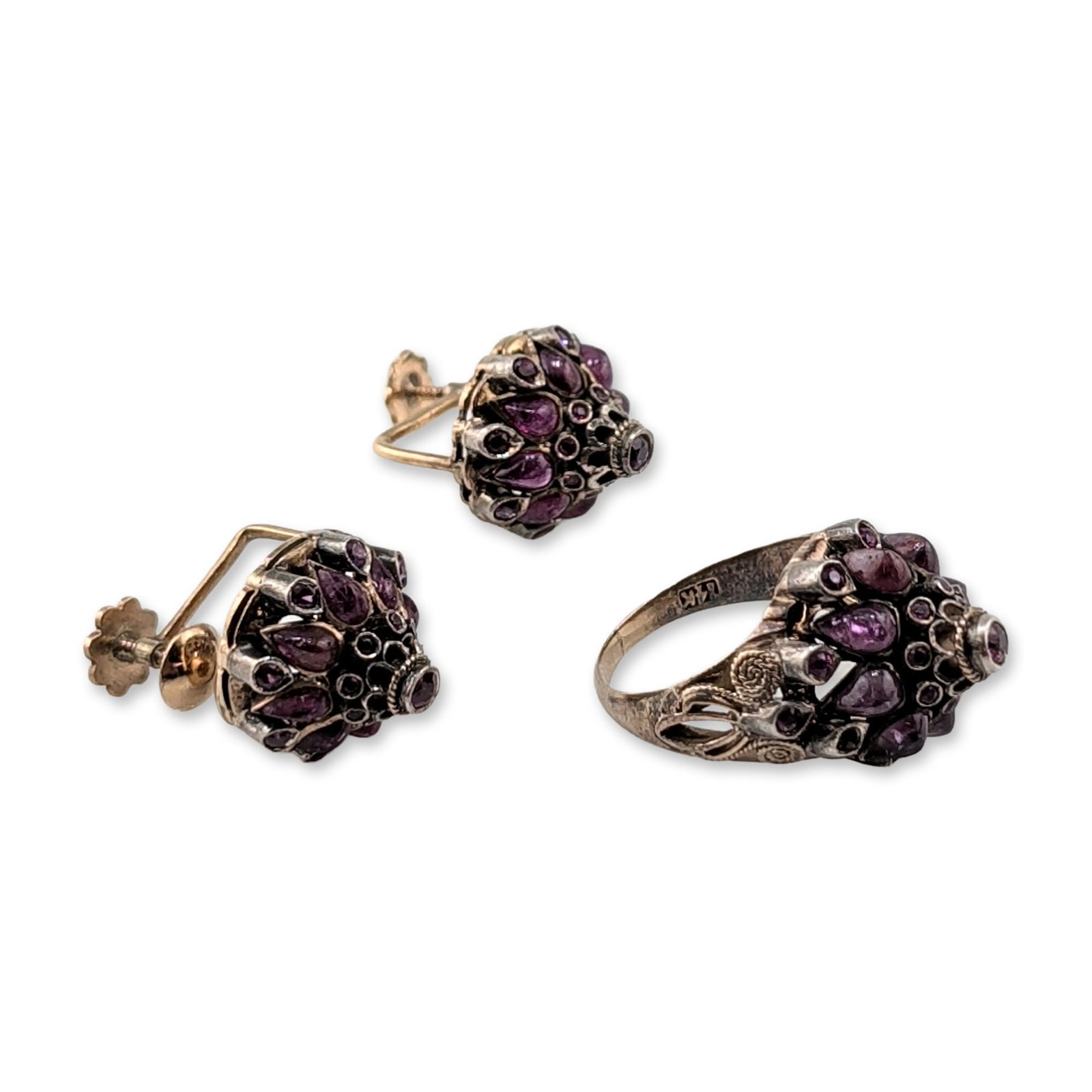 3pc Thai Princess Style Gold with Gemstones Ring and Screw-back Earrings: Featuring a tiered, high-dome design. The suite includes a cocktail ring and matching screw-back earrings, each set with multiple pear and round-cut purple gemstones, likely garnets. The settings