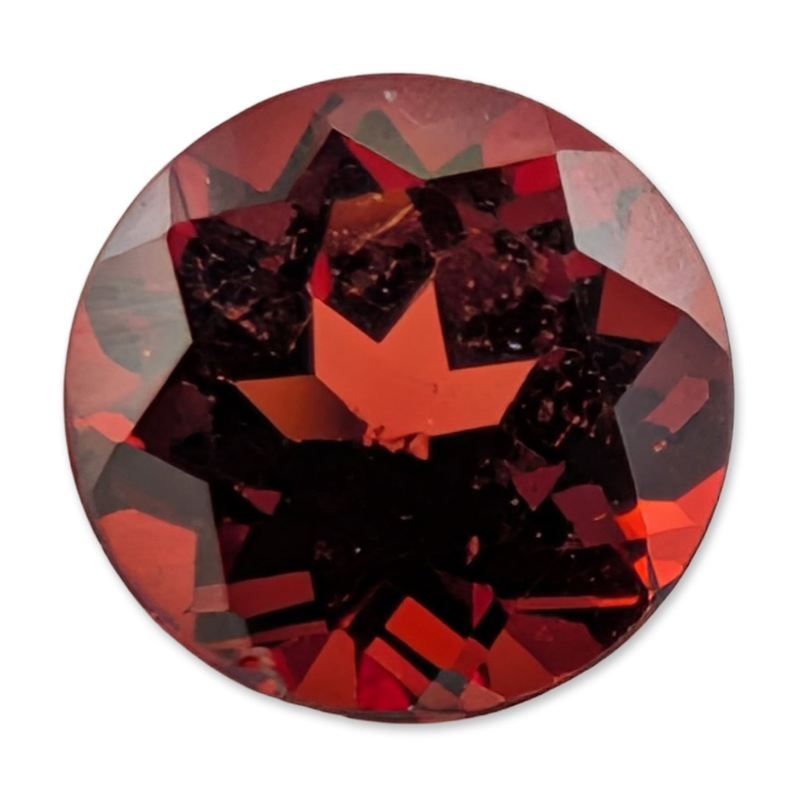 Loose Round Brilliant Cut Red Garnet Gemstone: Faceted red gemstone appearing to be a garnet, featuring a round brilliant cut with deep red saturation and mahogany tones. The specimen exhibits small internal crystalline inclusions and a minor feat