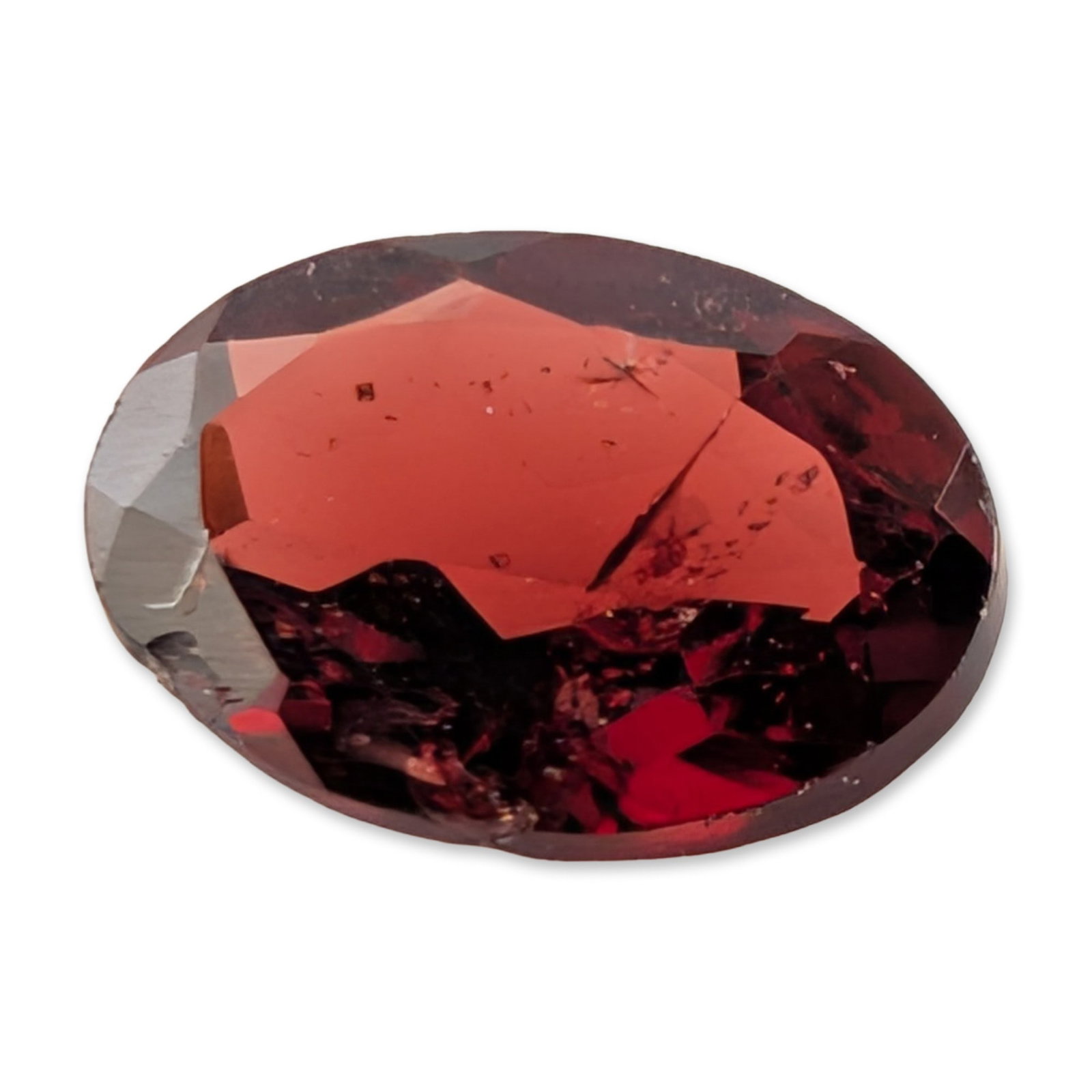 Oval Cut Red Garnet Gemstone: Loose faceted red gemstone, which appears to be a garnet, displaying a saturated deep red hue with subtle brownish-red undertones. The stone is presented in an oval faceted cut. Testing with a Presidi
