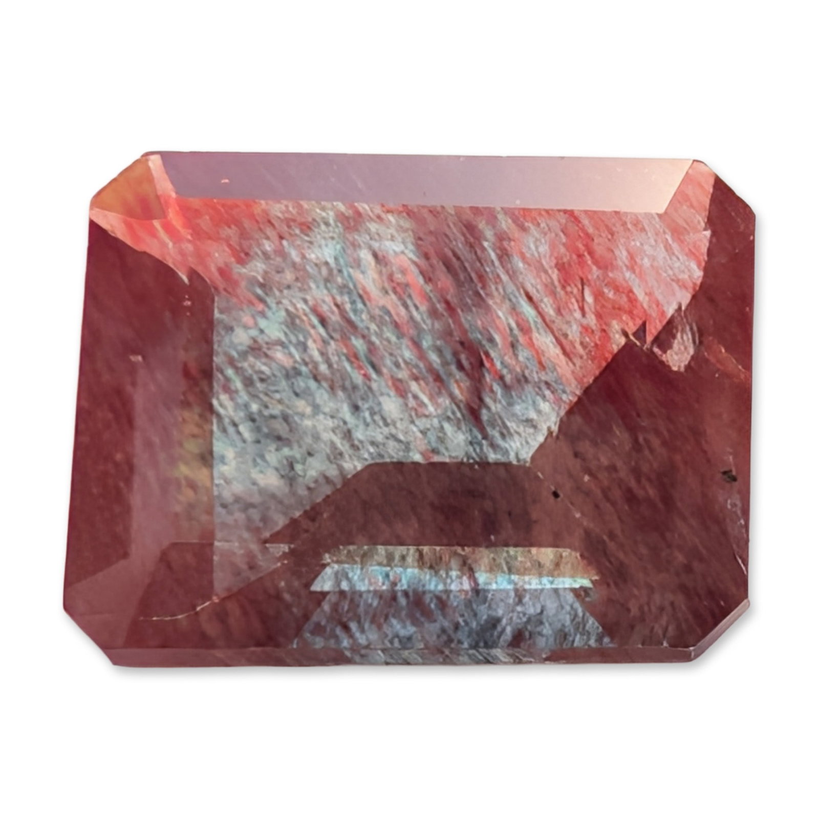 Bicolor Oregon Sunstone Emerald Cut Gemstone: Loose faceted gemstone appearing to be a bicolor Oregon sunstone, featuring a rectangular emerald cut. The stone displays distinct color zoning with a primary terracotta-red hue and a secondary zone o