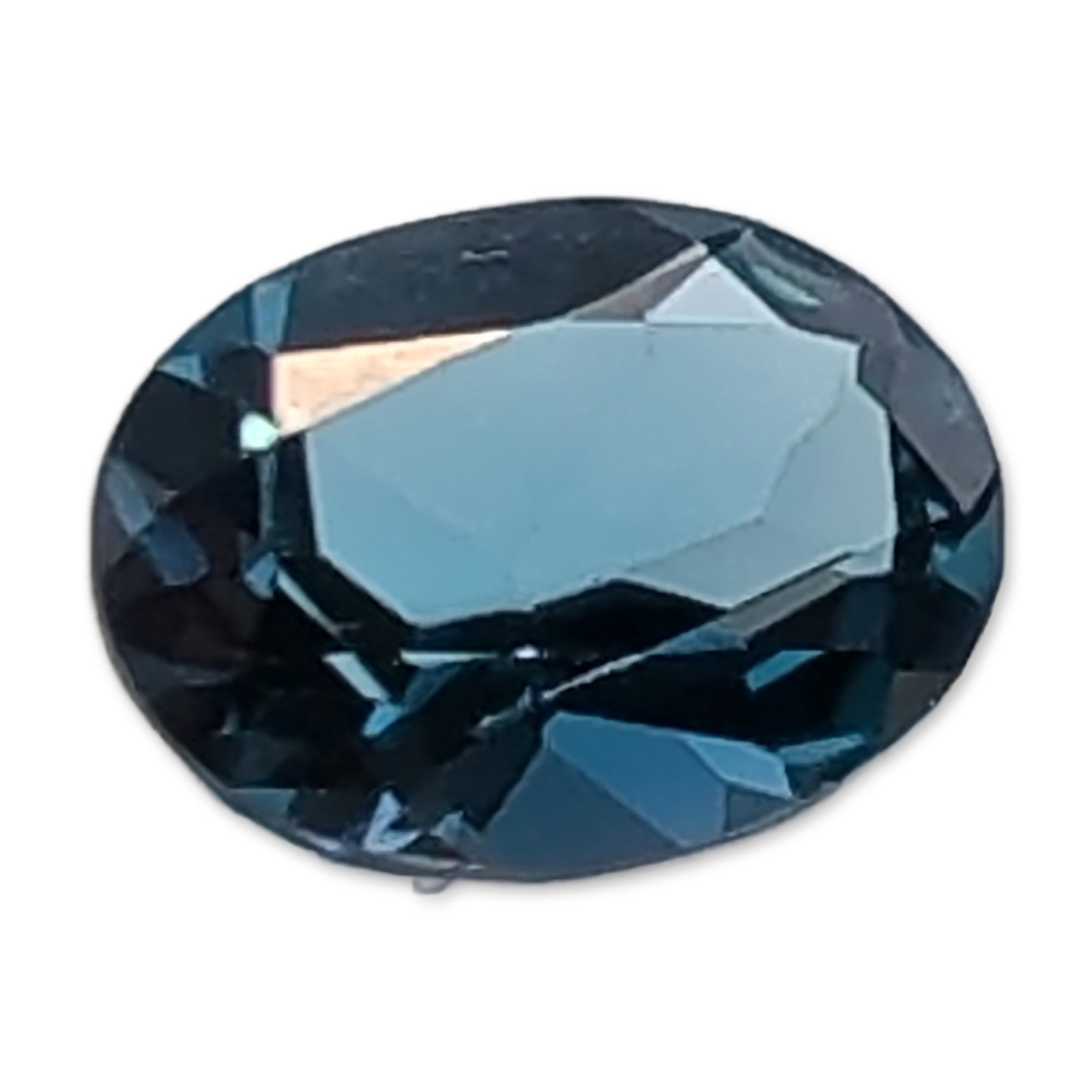 Oval Faceted London Blue Topaz Gemstone: Oval faceted gemstone appearing to be a London Blue topaz, characterized by a deep, saturated teal-blue hue. The stone features a bright, polished luster with sharp facet junctions. No formal