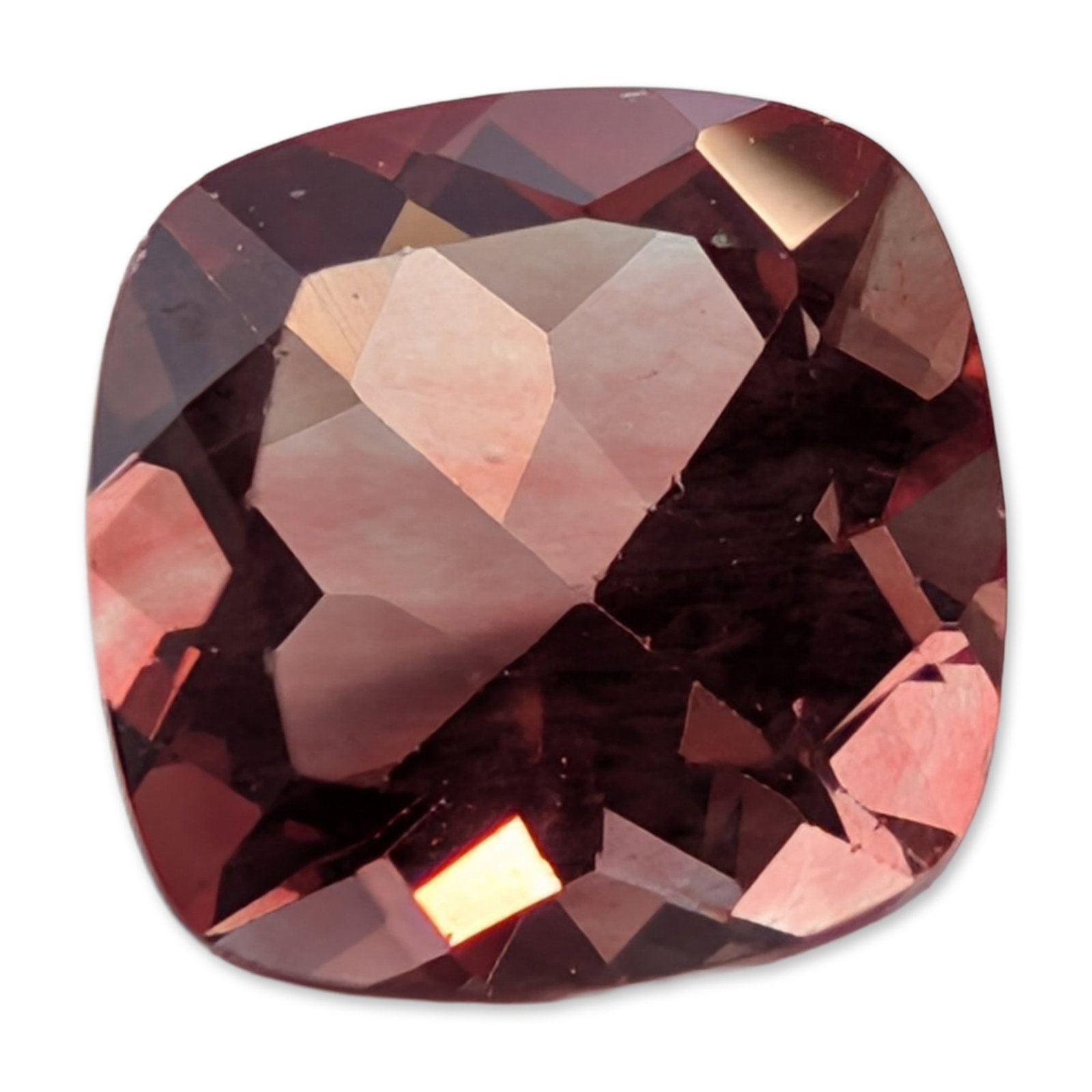Loose Cushion Cut Pinkish Orange Stone: Loose faceted stone featuring a cushion-modified brilliant cut. The stone displays a saturated pinkish-orange hue. It exhibits high transparency and brilliance, appearing eye-clean to the naked eye.