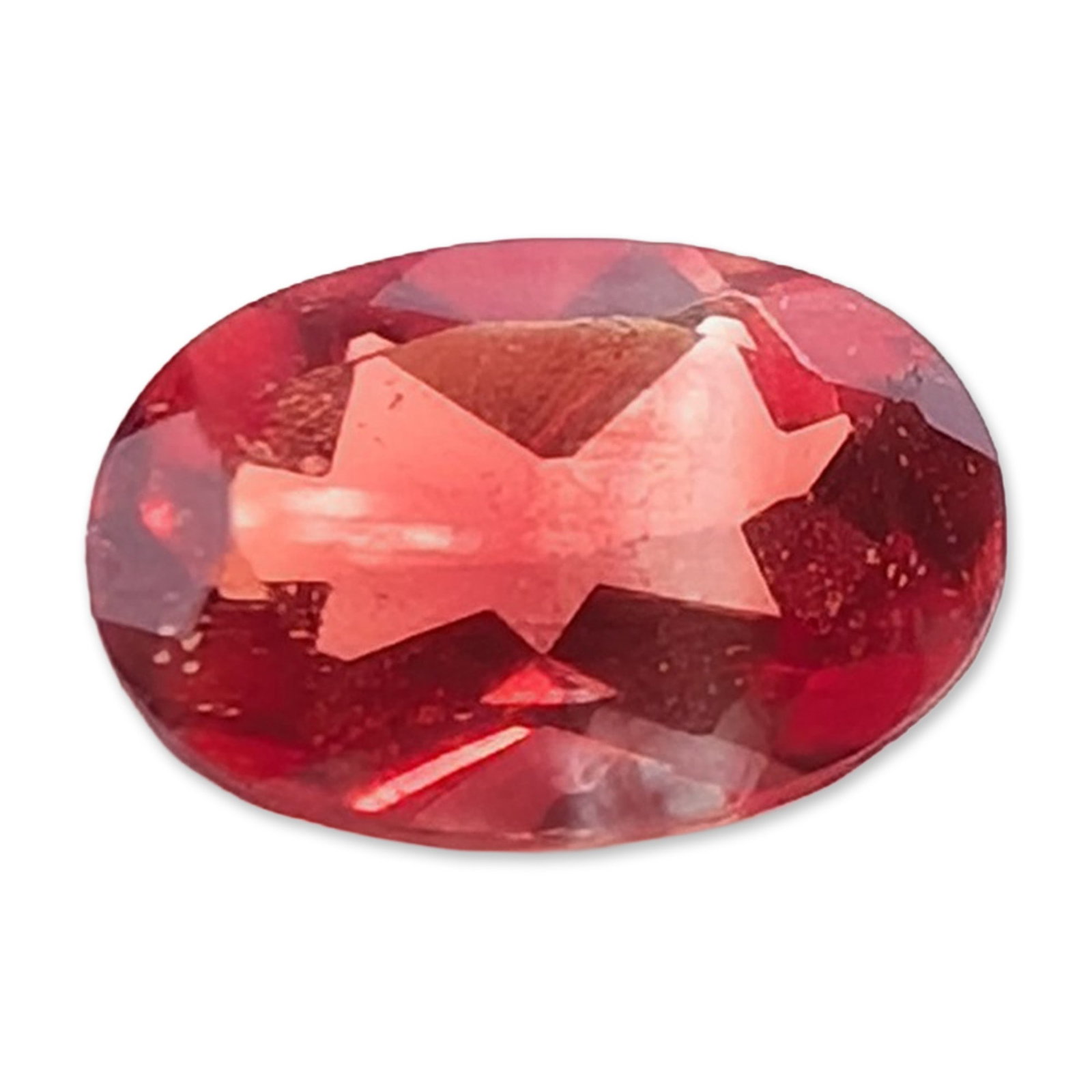 Oval Mixed Cut Red Stone: Oval mixed cut red gemstone. The stone displays a deep purplish-red hue. 0.3 ct6.0 mm. Dimensions: 6.0mm