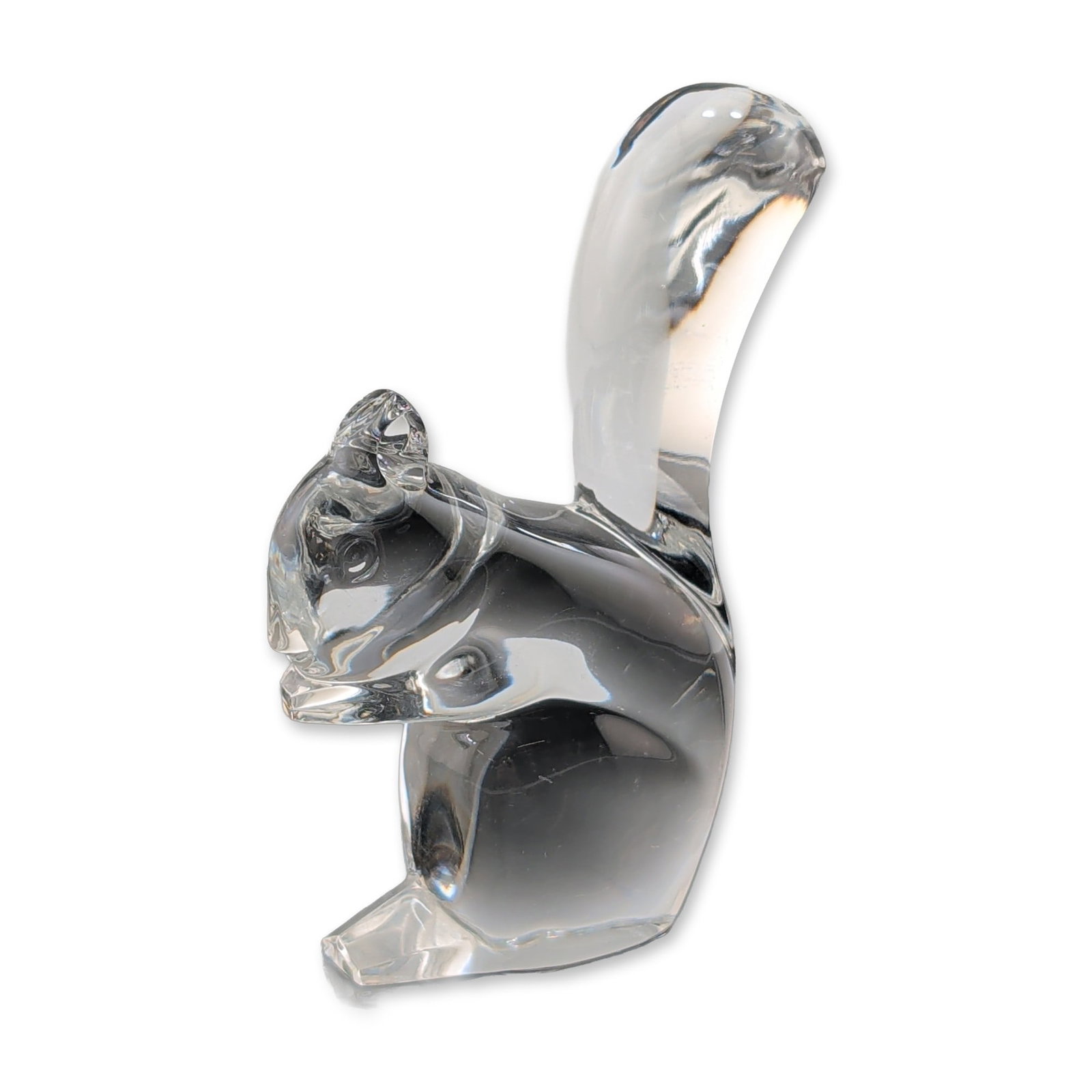 Baccarat Clear Crystal Squirrel Sculpture: This modern sculpture of a squirrel by Baccarat features a highly stylized design executed in heavy clear lead crystal. The minimalist animal form is characterized by smooth geometric planes, clean li