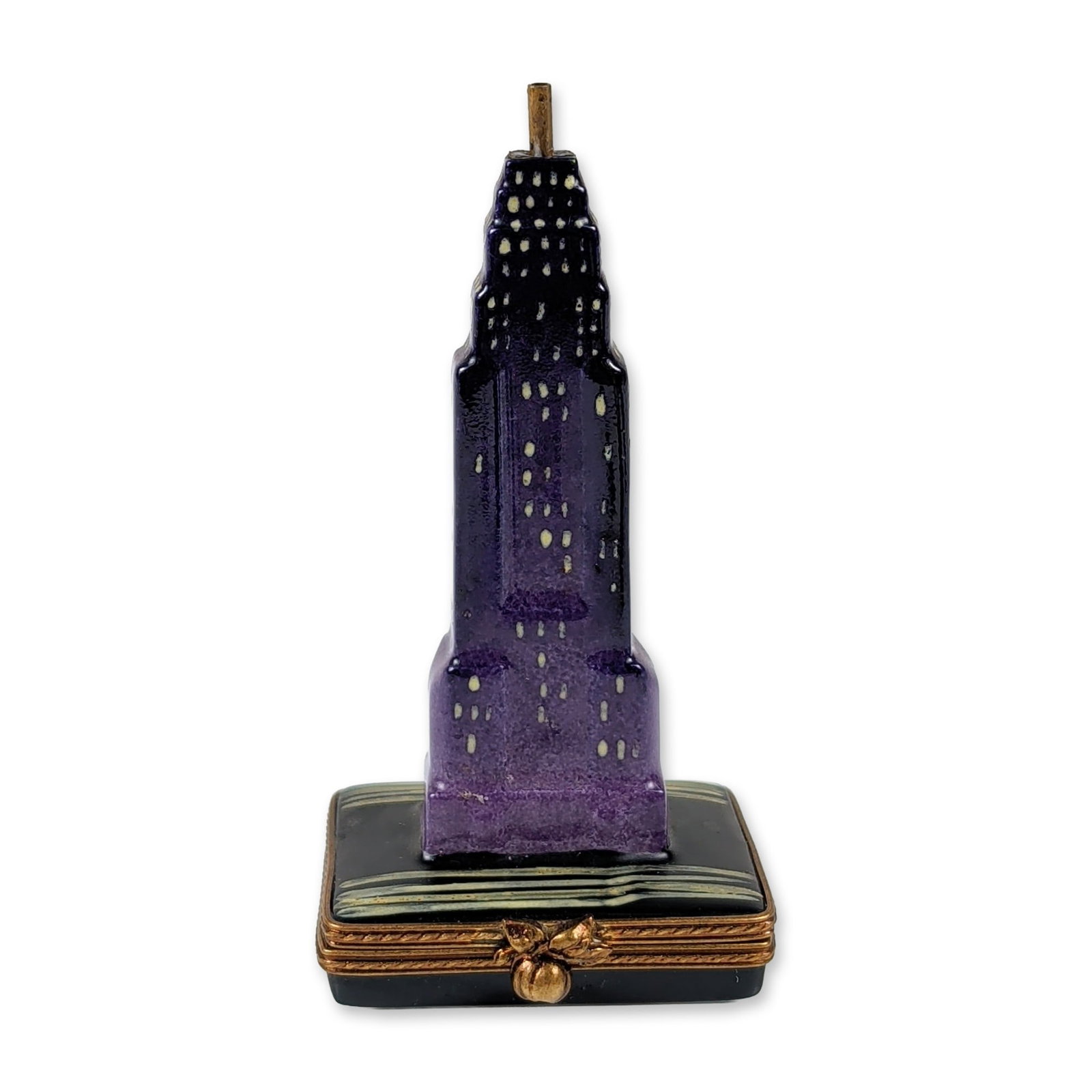 Limoges Empire State Building Porcelain Skyscraper Box: Limoges hand painted porcelain box modeled as an Art Deco tiered skyscraper at night. The exterior features a dark purple to black gradient finish accented by hand painted yellow window lights, set on
