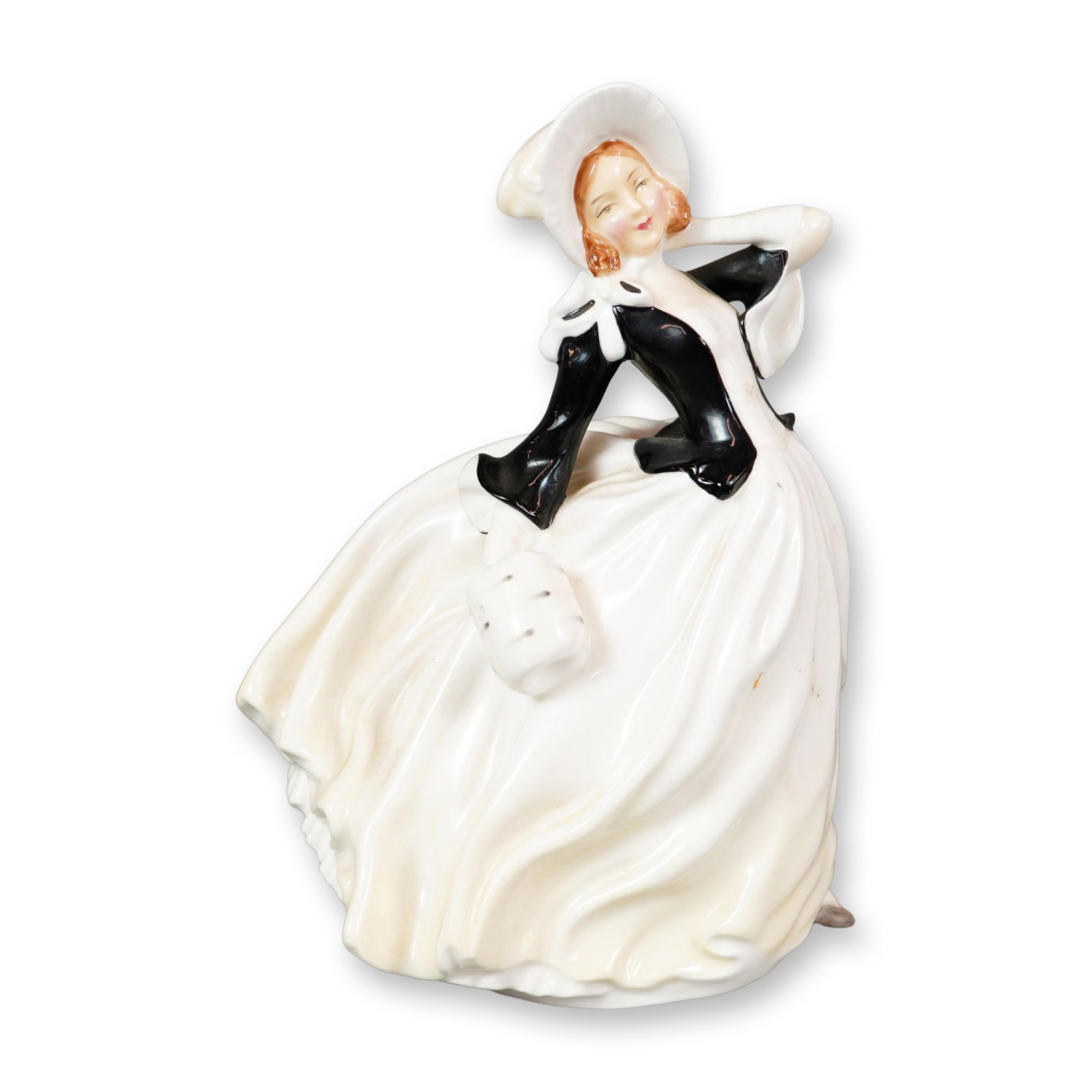 Royal Doulton Bone China Figurine, Autumn Breezes HN2147: Part of the Harradine Classics series, designed by Leslie Harradine. This hand-painted figurine portrays a young woman dressed in white and black, her flowing garments suggesting she is standing in a 