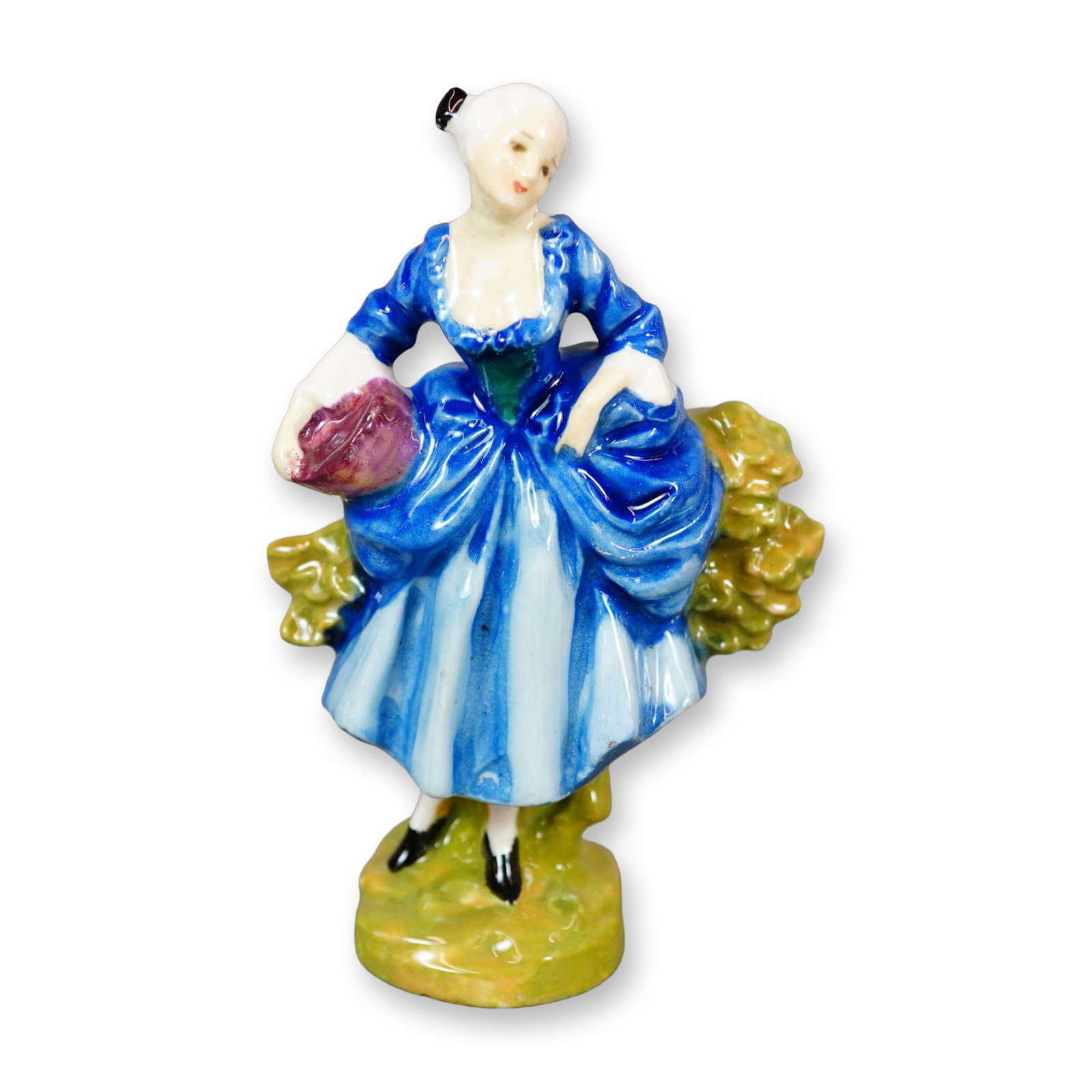 Doulton Colorway Porcelain Figurine, Shepherdess HN735: A Doulton figurine inspired by 18th-century Chelsea figures and designed by Leslie Harradine, depicting a shepherdess dressed in blue tones with a green bodice. It was issued as a companion piece to S