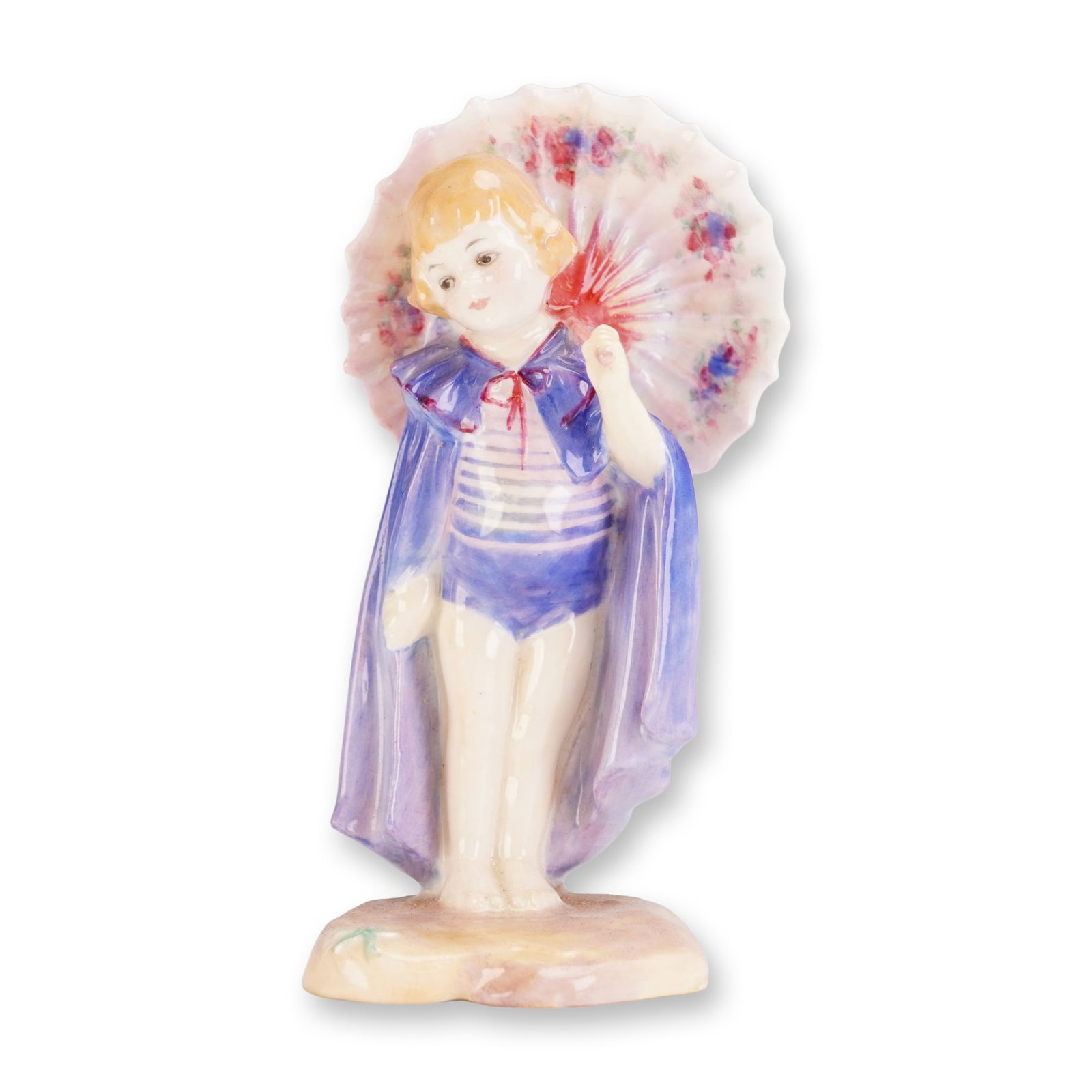 Royal Doulton Porcelain Figurine, Babette HN1424: Designed by Leslie Harradine, circa 1930. The figure depicts a young girl in a blue and white striped swimsuit with a flowing blue cape tied with a red bow, holding a floral-patterned parasol. Hand-pa