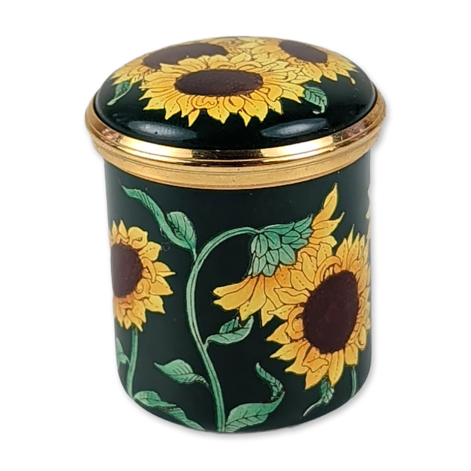 Halcyon Days Sunflower Enamel Box: Halcyon Days English enamel trinket box of cylindrical form with a twist-off lid. The exterior features a polychrome sunflower and leaf design against a dark forest green ground, finished with polishe